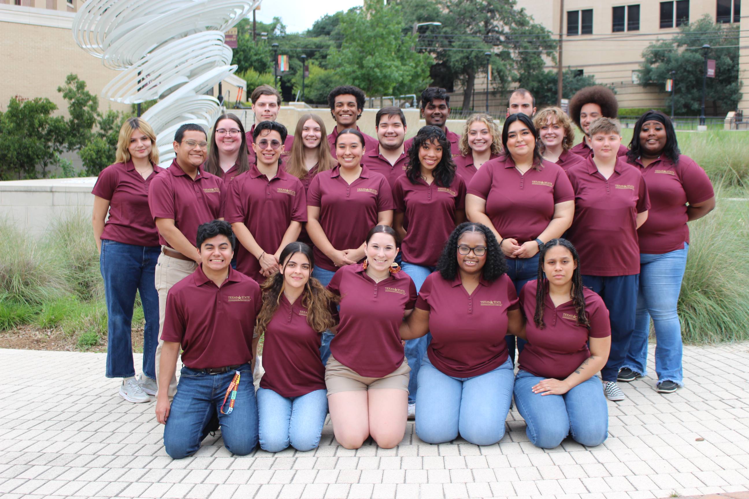students in gold texas state shirts smiling