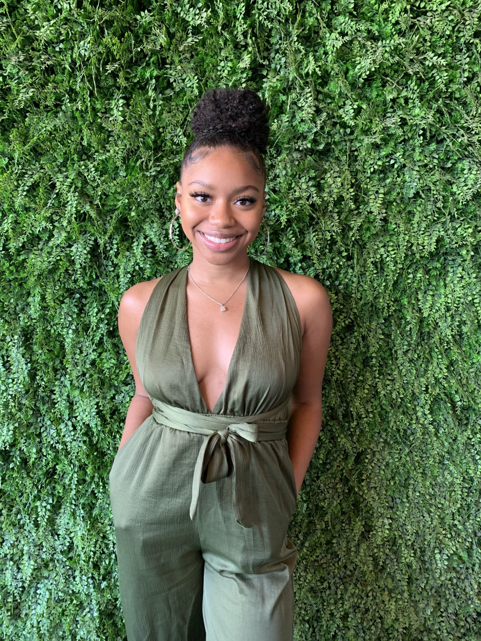 Amiya Ward standing in front of greenery