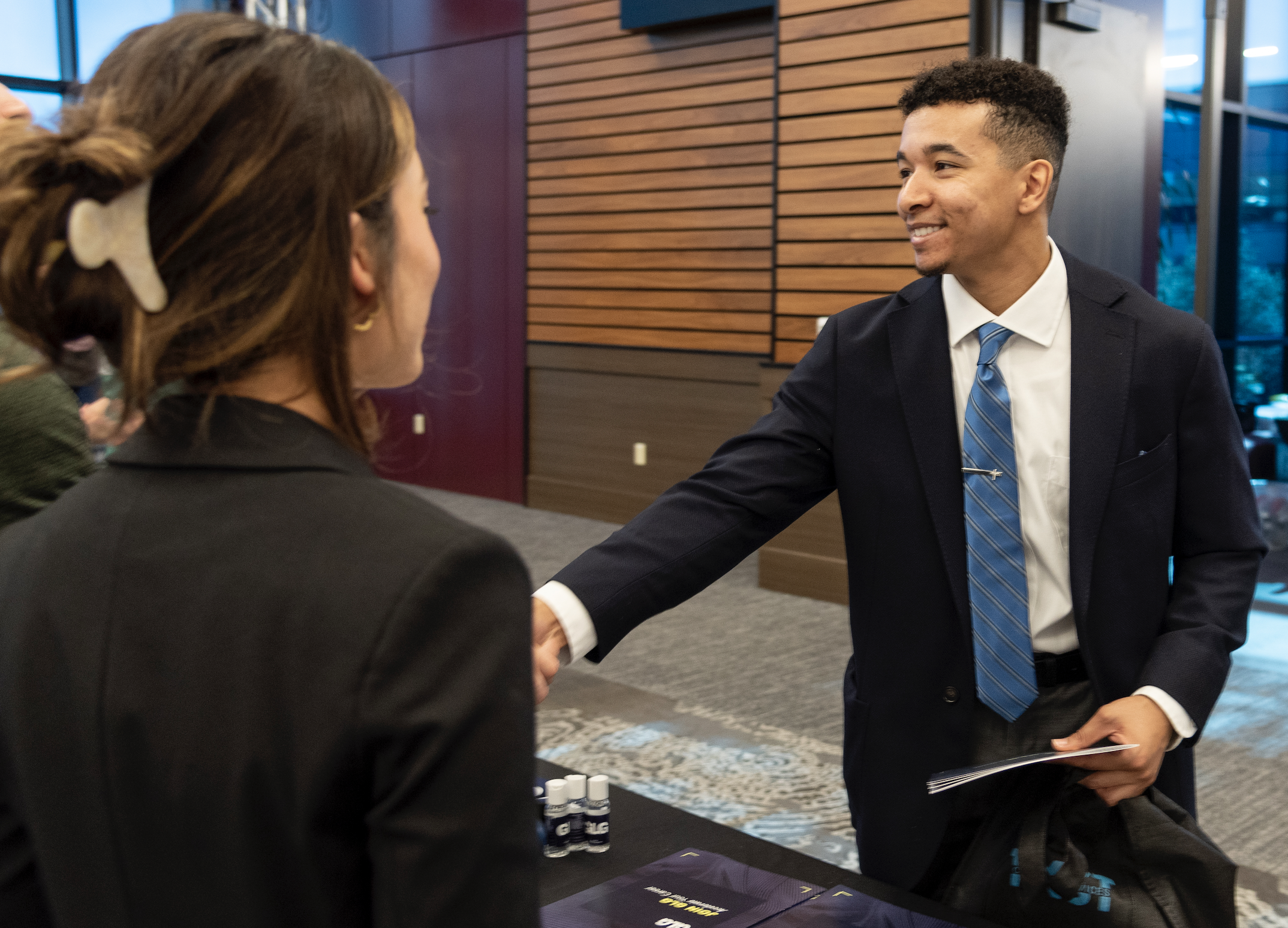 Student shaking hands at career fair