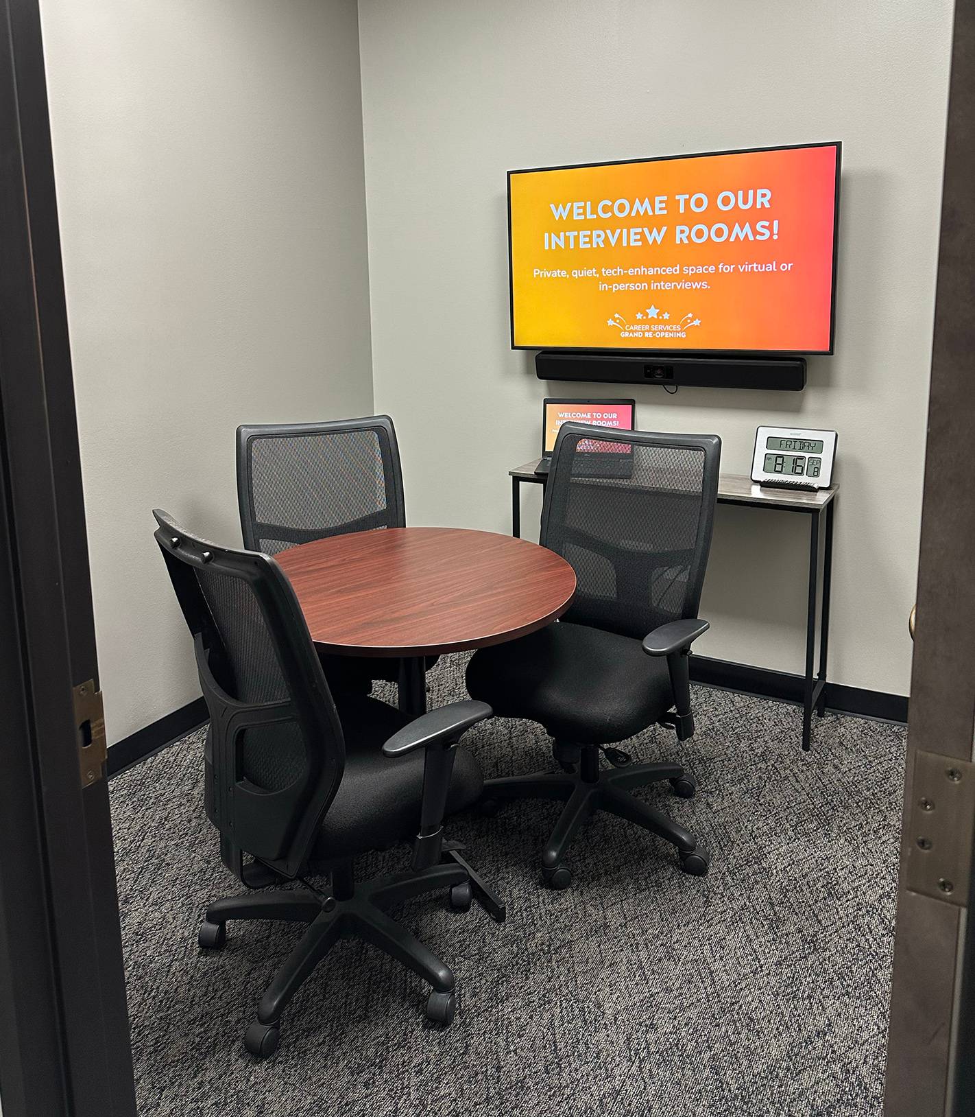 interview room with small table and large tv