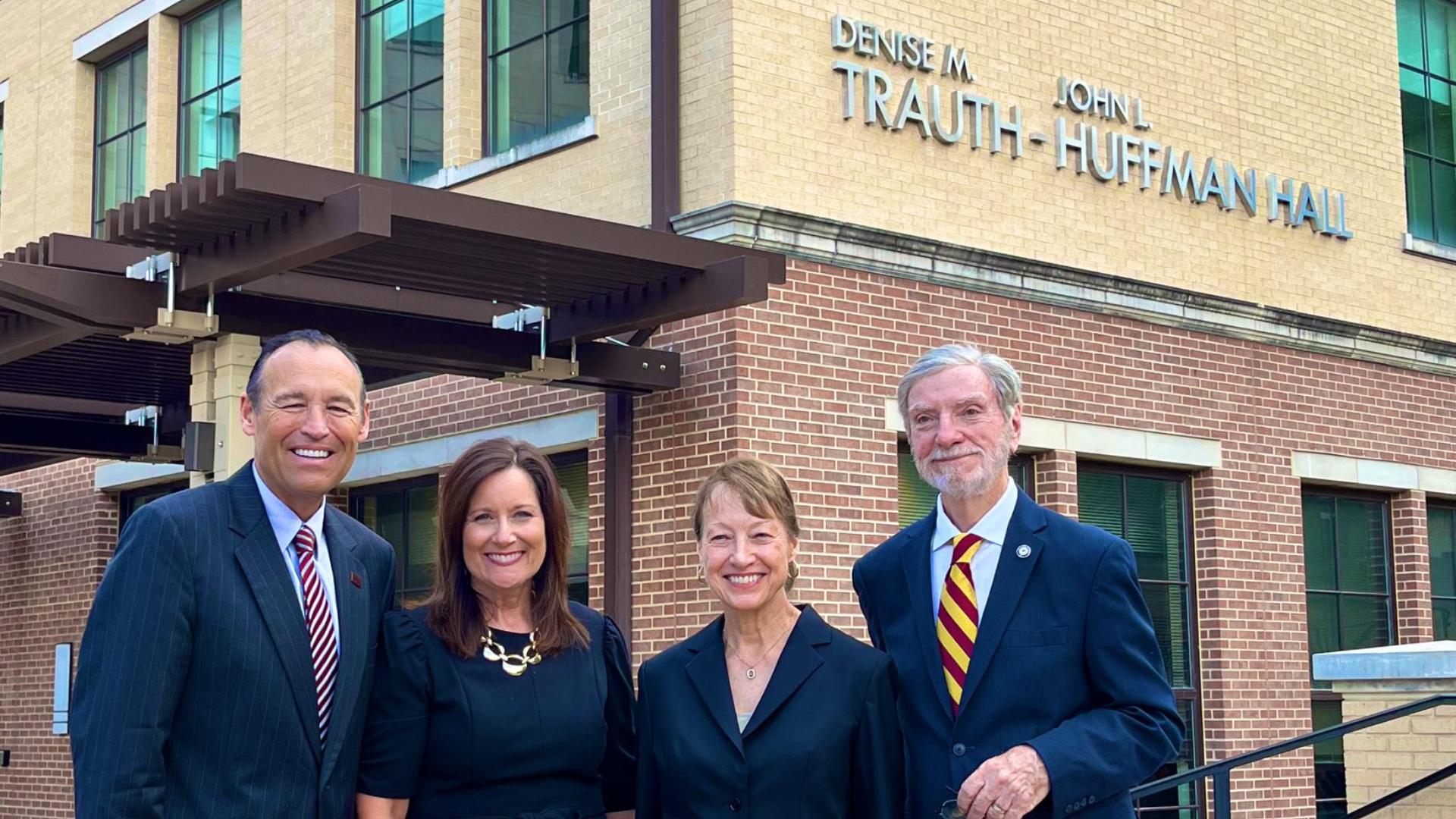 President Damphousse, Beth Damphousse, Denise M. Trauth, and John Huffman Hall take a photo in celebration of the renaming of University Academic Center to Denise M. Trauth and John Huffman Hall.   