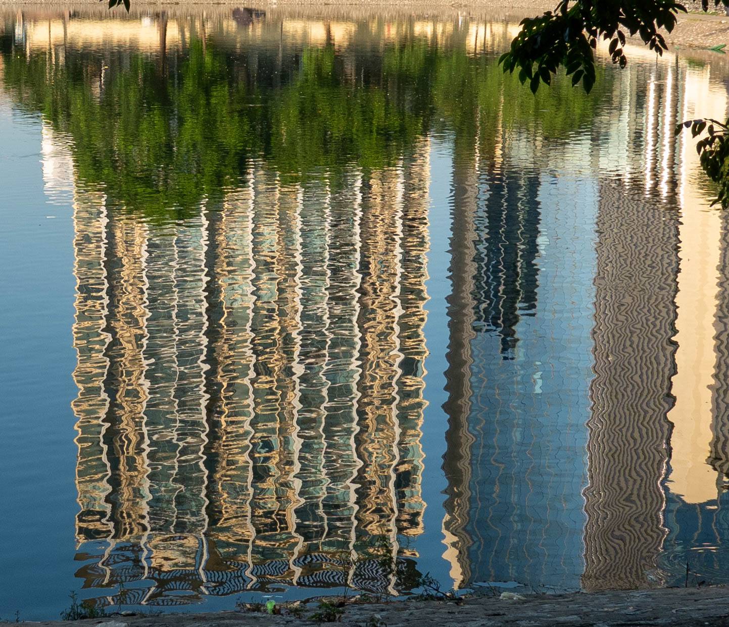 Reflection of building in lake distored by ripples. 