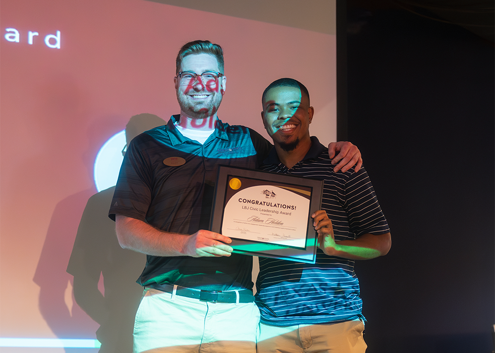 Adam Holden receiving and posing with Civic Leadership Award for 2023