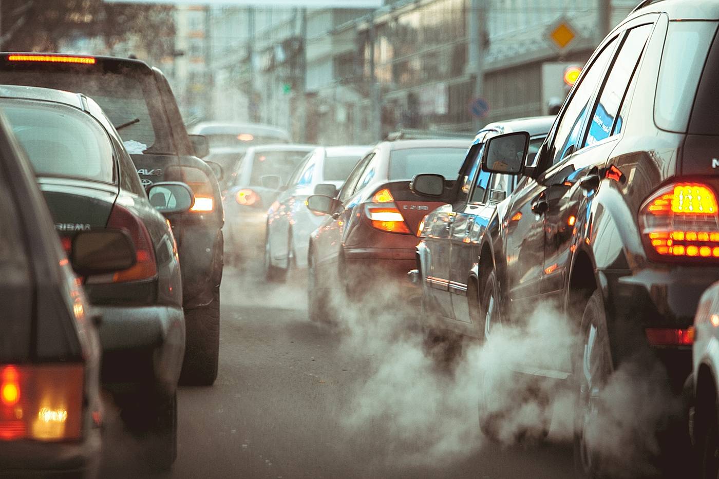 Cars stuck in traffic on a busy city street.