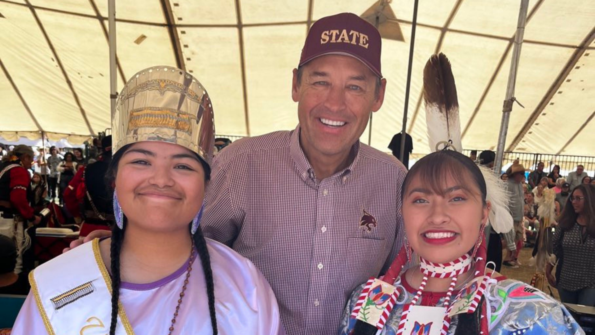 President Damphousse posing with two students at the Sacred Spring Powwow.
