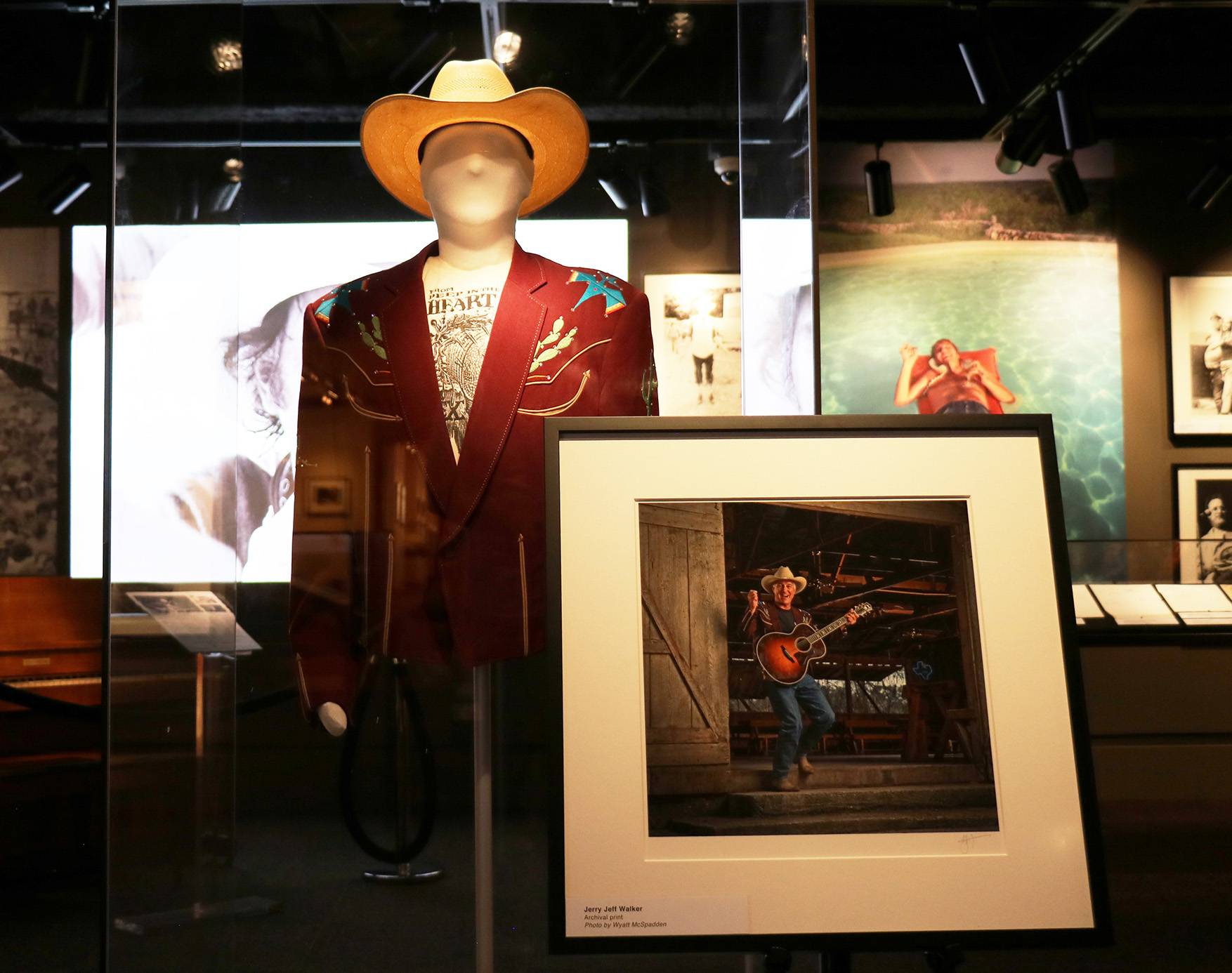 mannequin wearing a cowboy hat and jacket next to a framed picture of Jerry Jeff Walker
