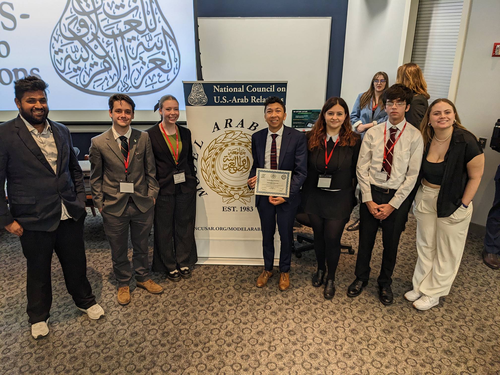 group of student in business attire at model arab league meeting