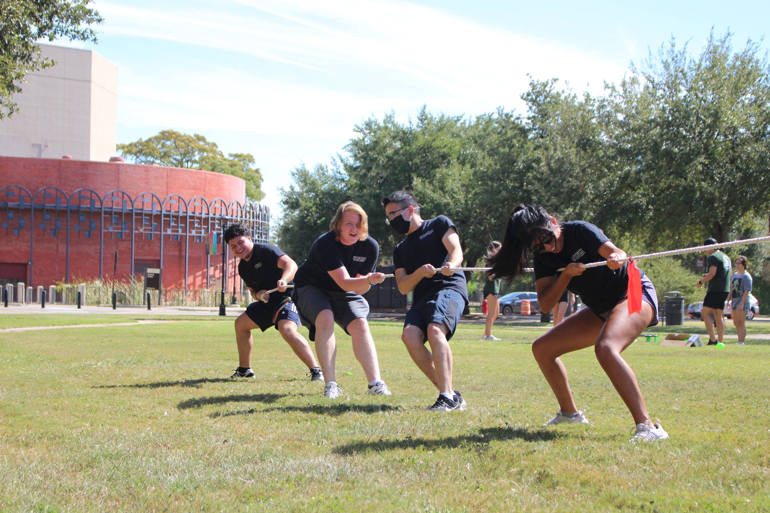 Four people playing tug of rope