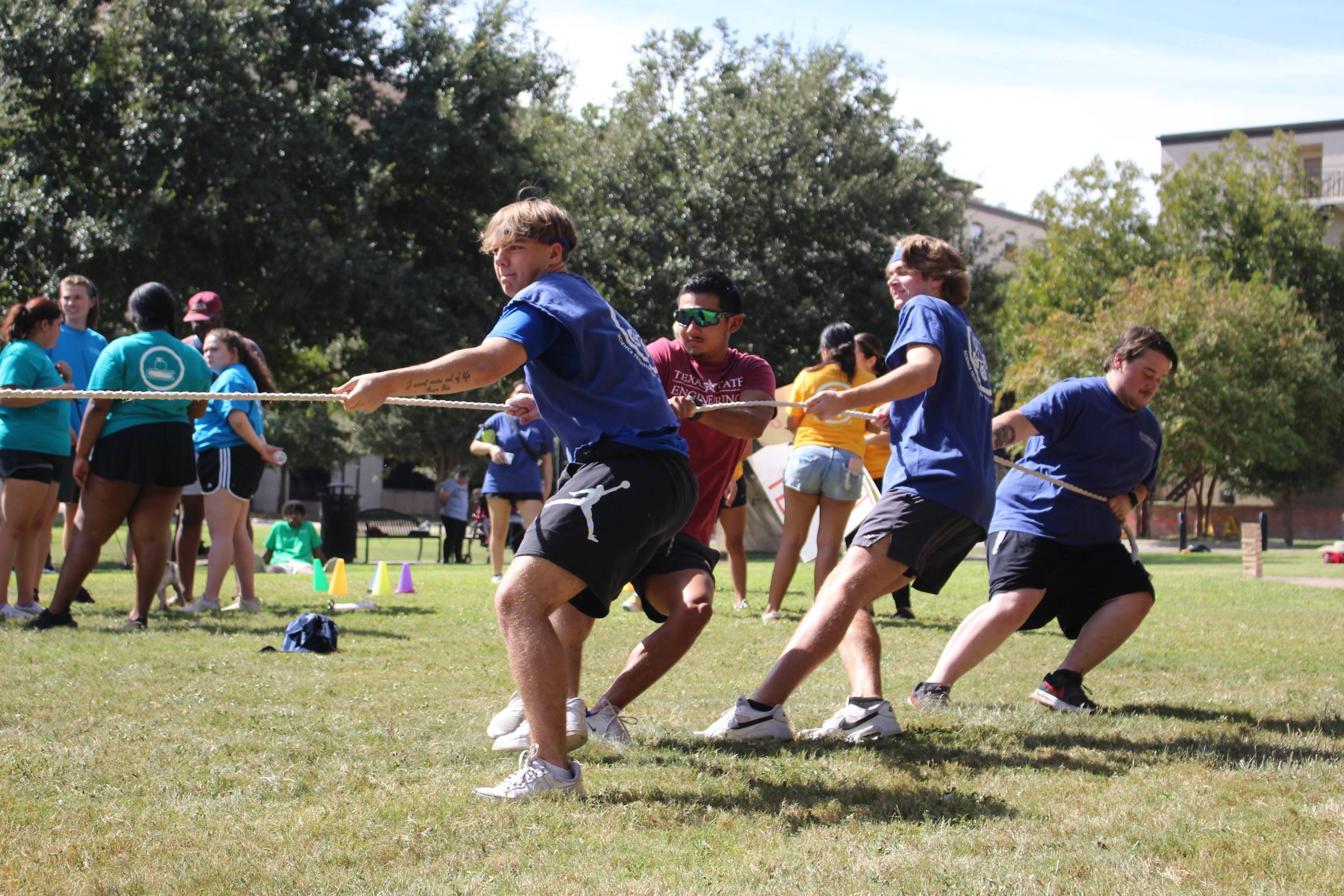 Four boys playing tug of war