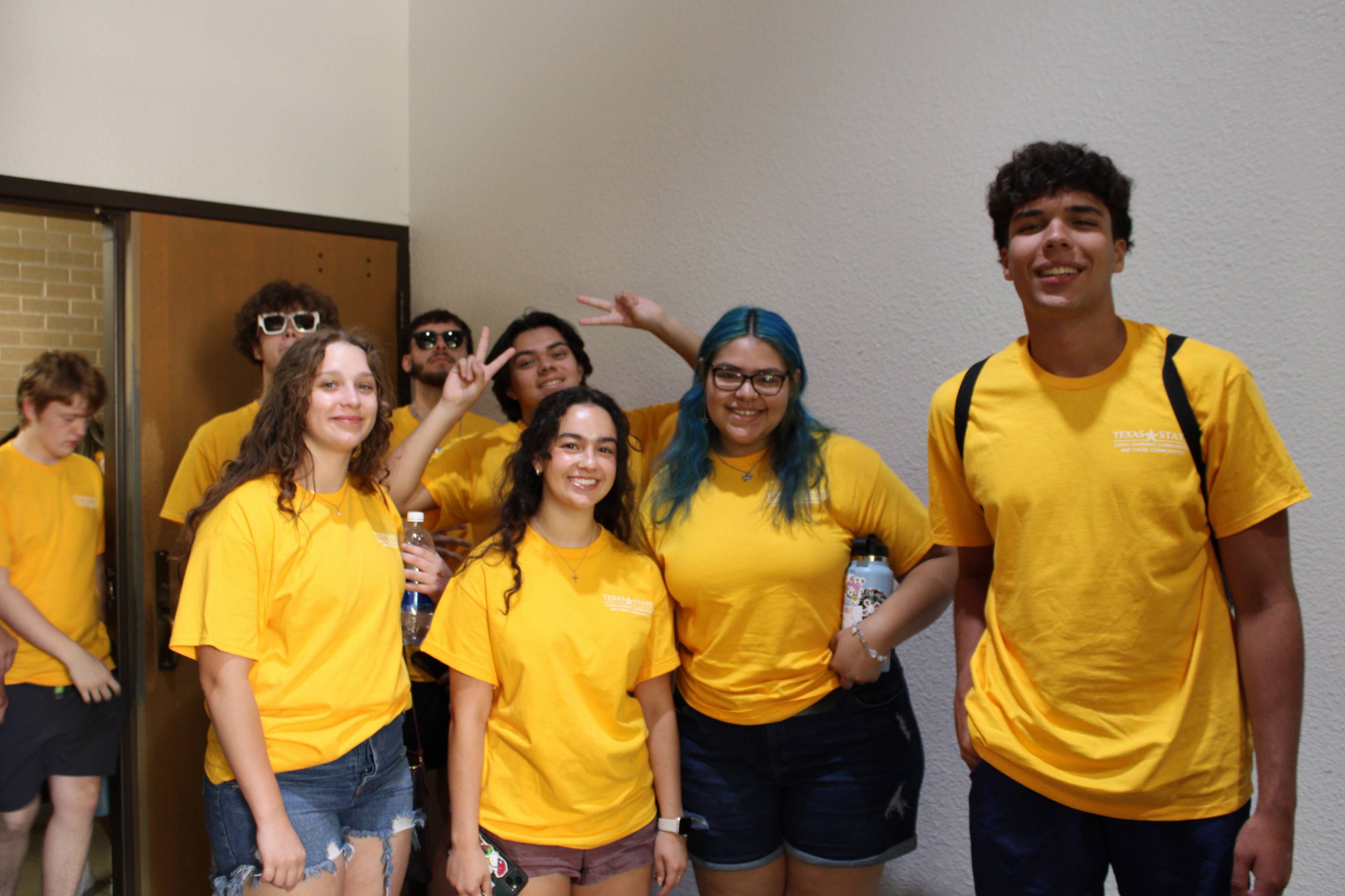 Group of students in matching yellow shirts 