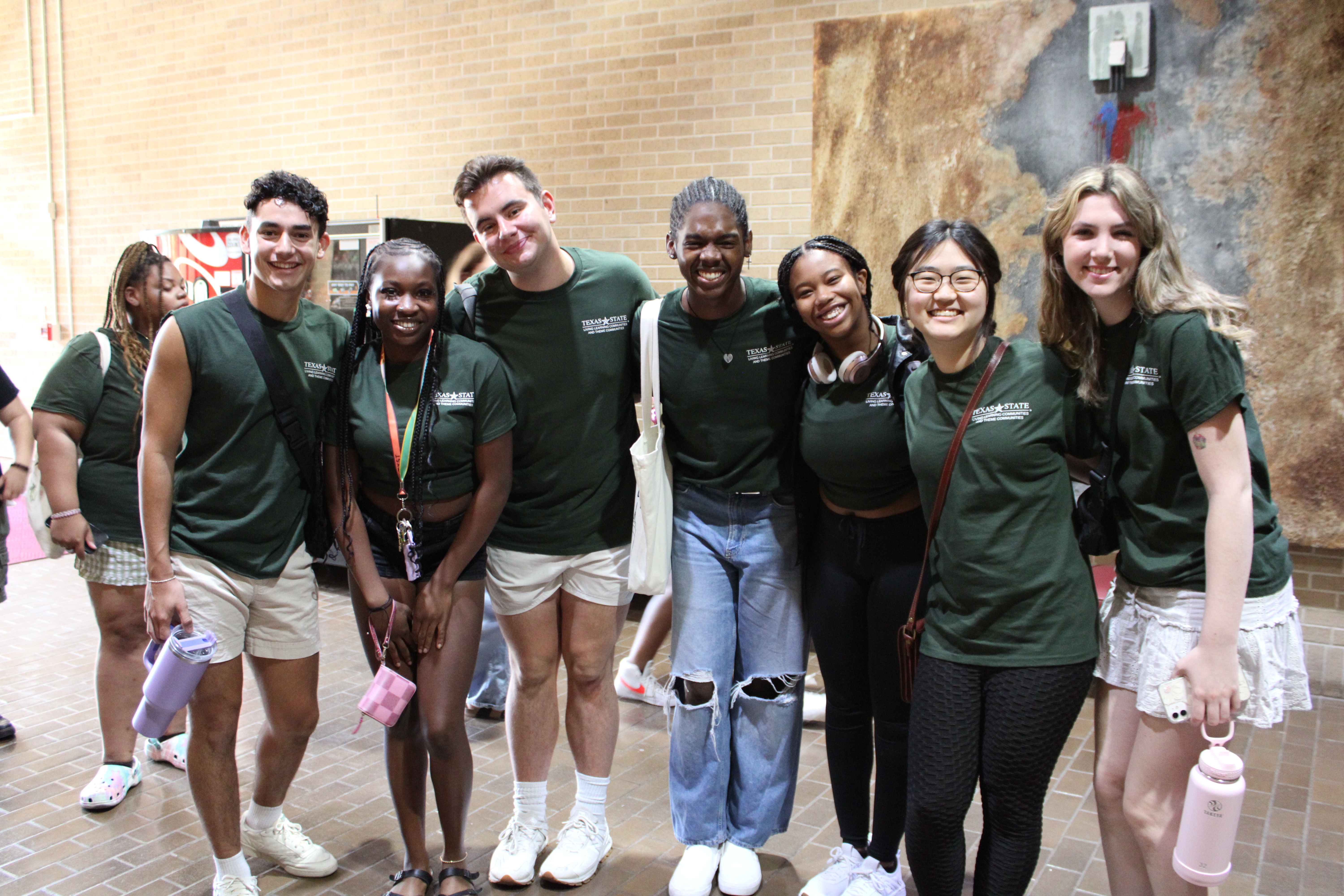 Group of students in matching green shirts