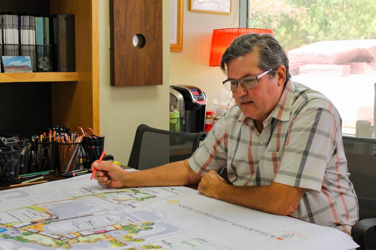man looking at engineering drawings
