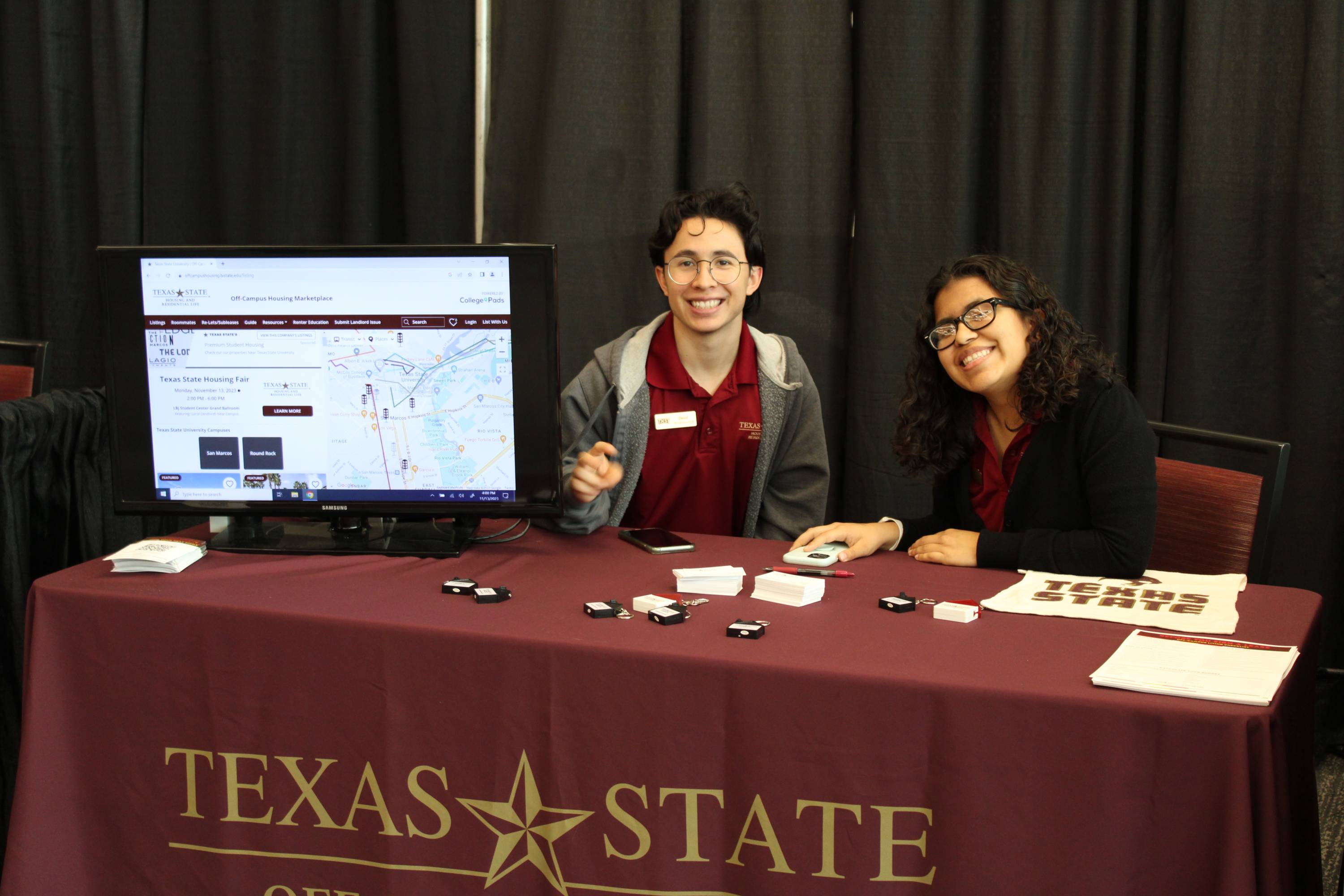 Two students sitting at a table that says Texas State