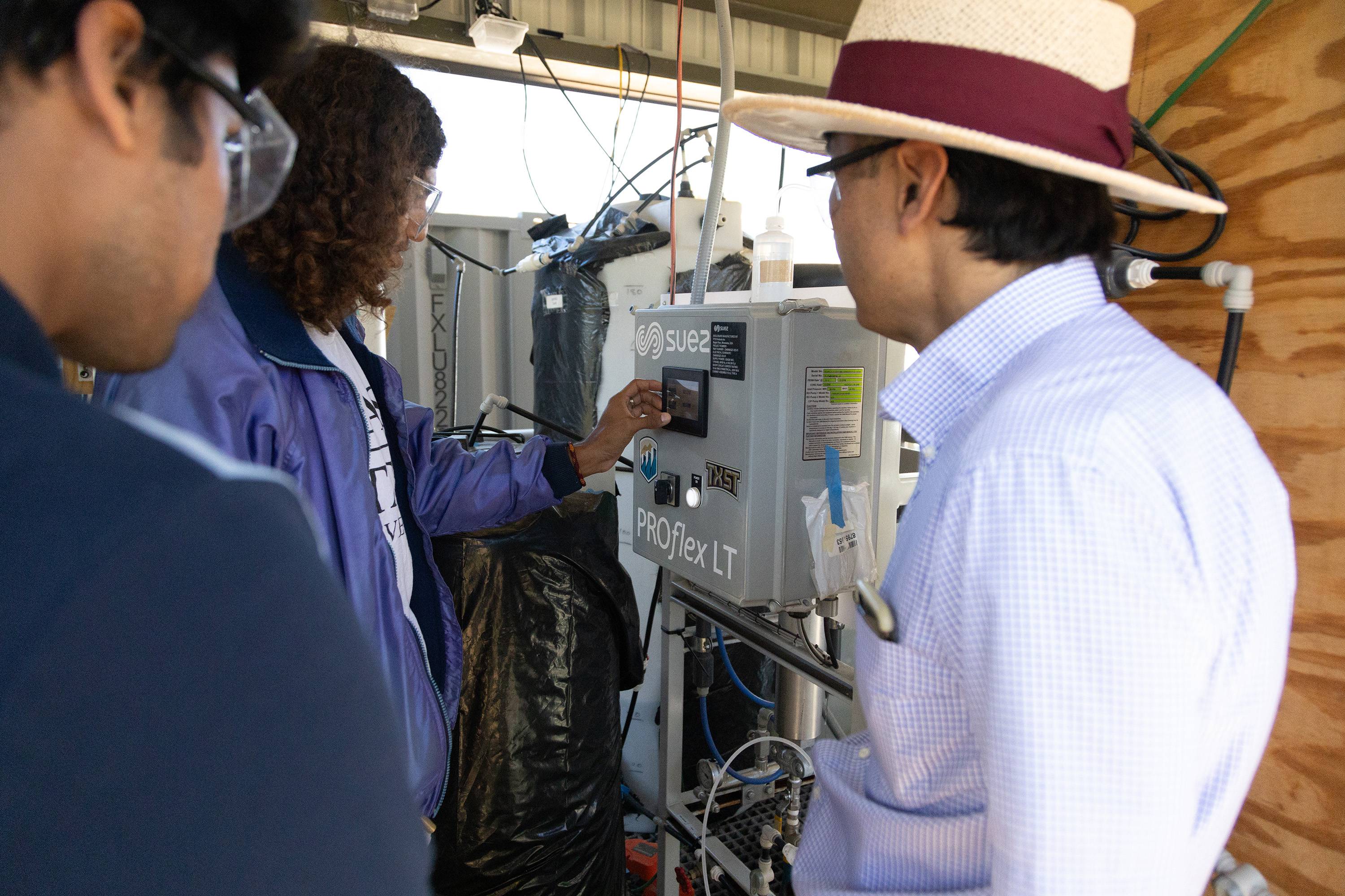 carlos espindola and other researchers at a wastewater treatment plant 