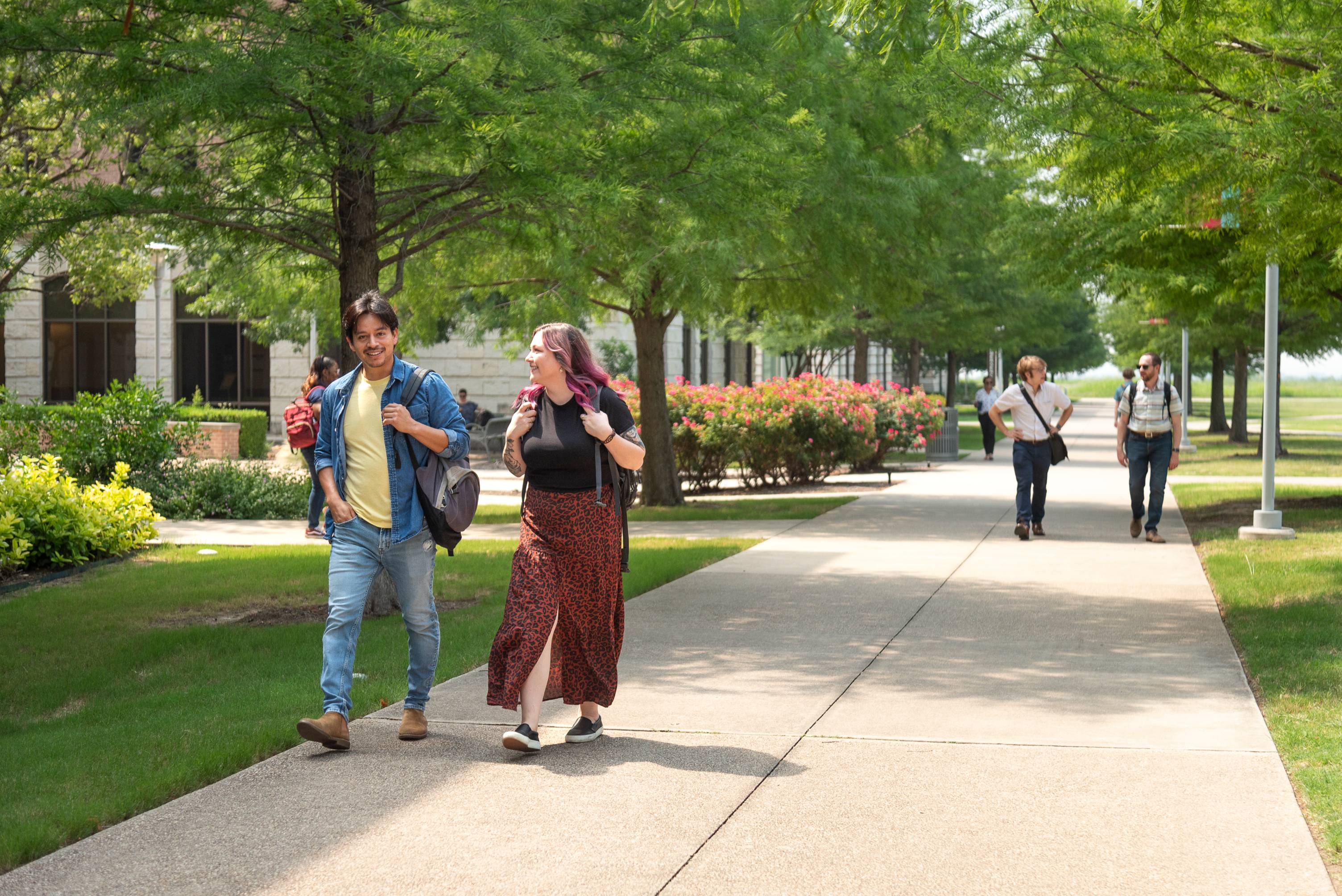 students walking outside on the sidewalk