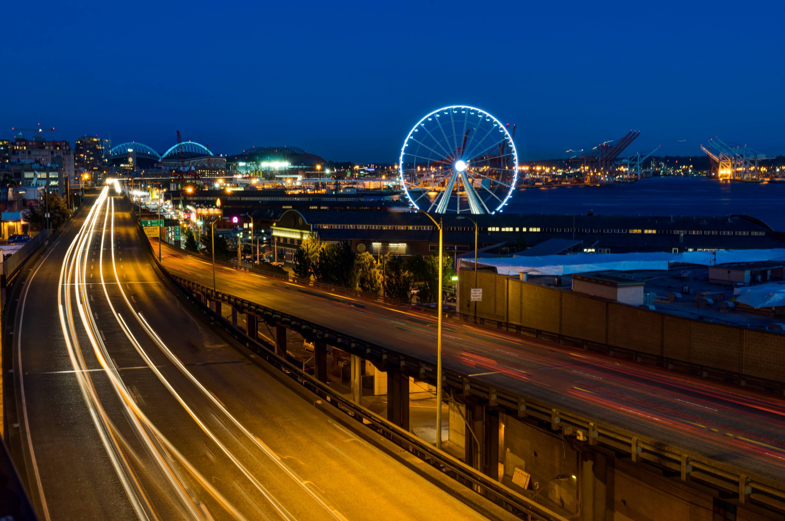 Seattle pier and Ferris wheel and water during nighttime image