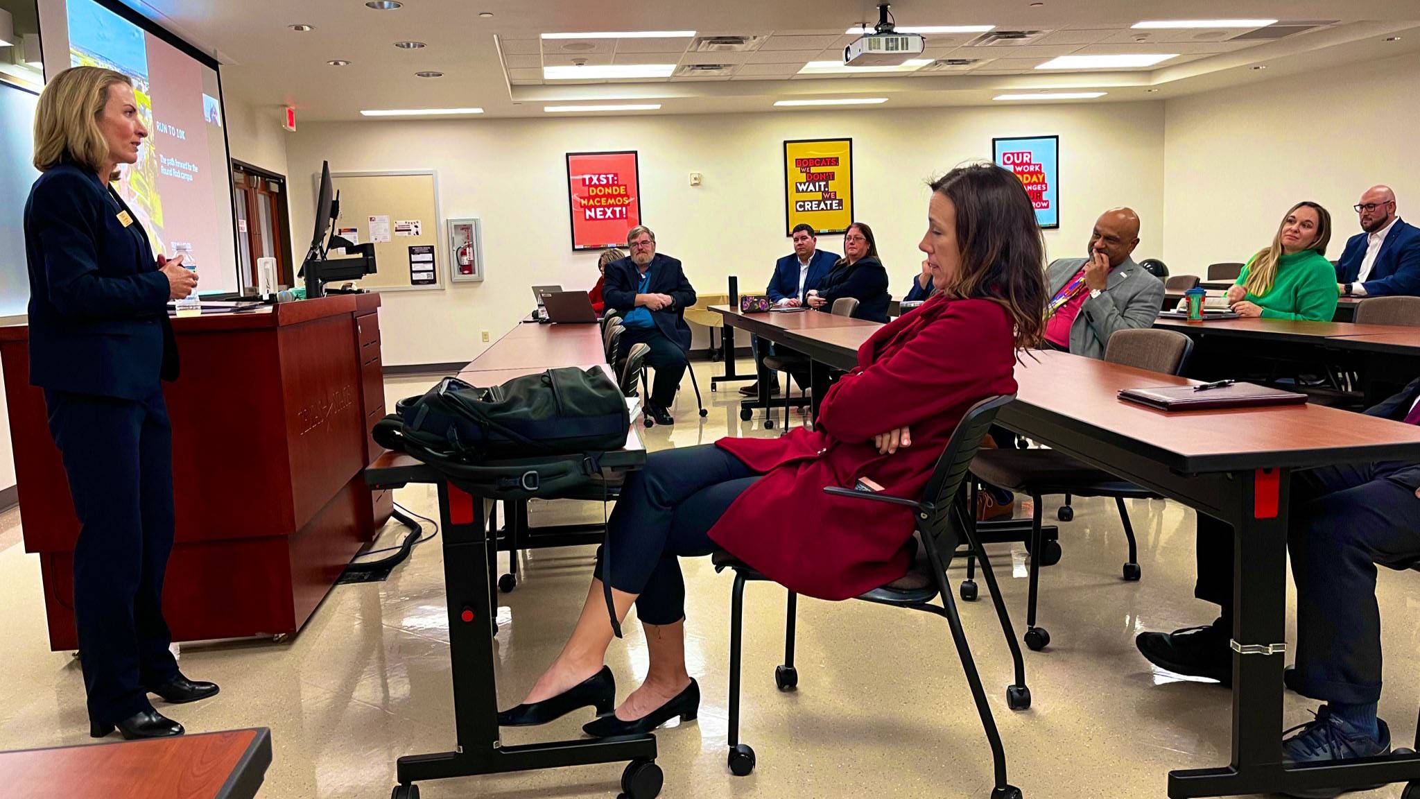 VP Julie Lessiter, left, speaks to a room of attendees at the Run to 10K Commission meeting.