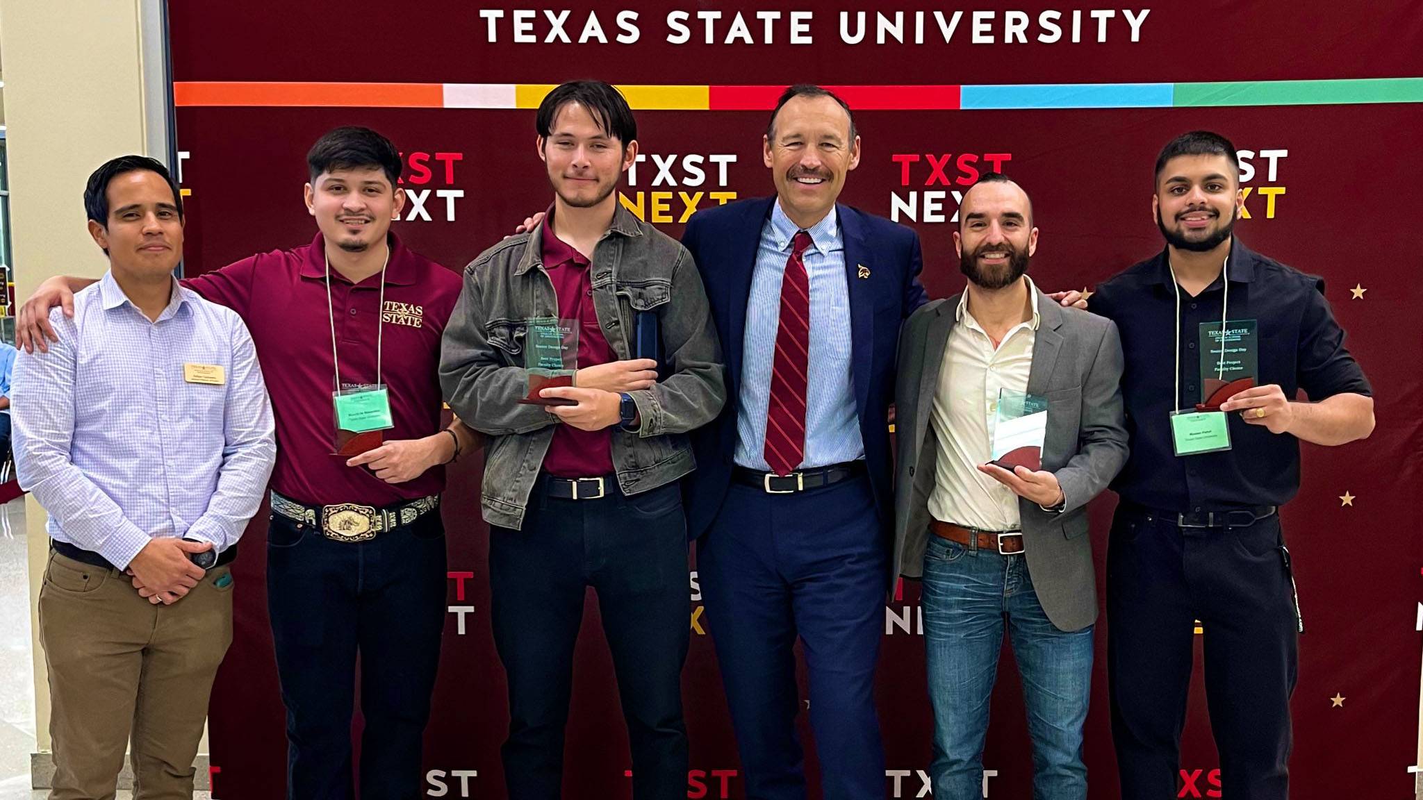 President Damphousse poses for a photo with award recipients.