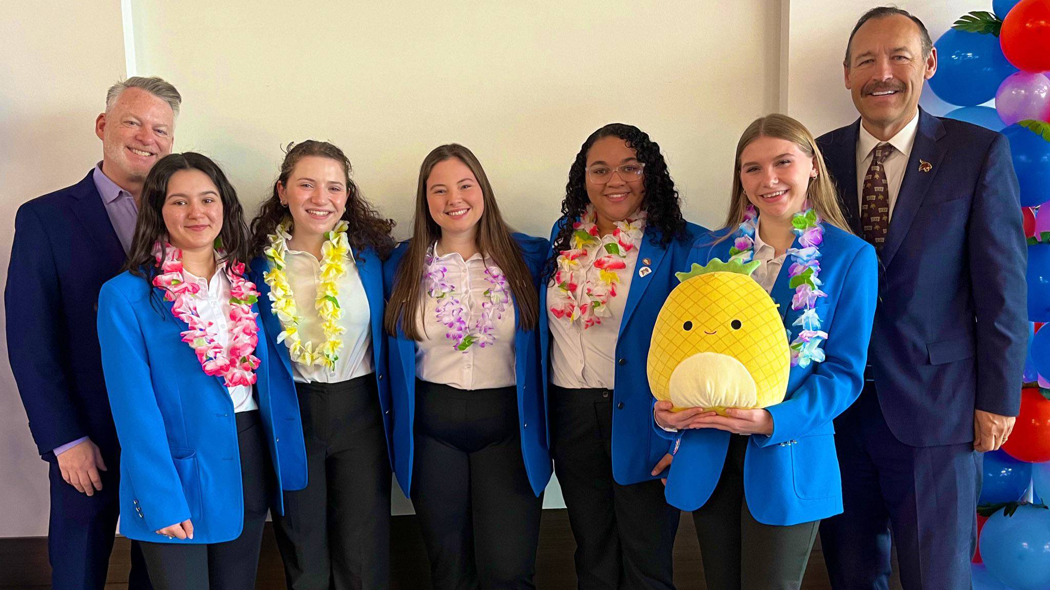 President Damphousse, right, poses for a photo with students.