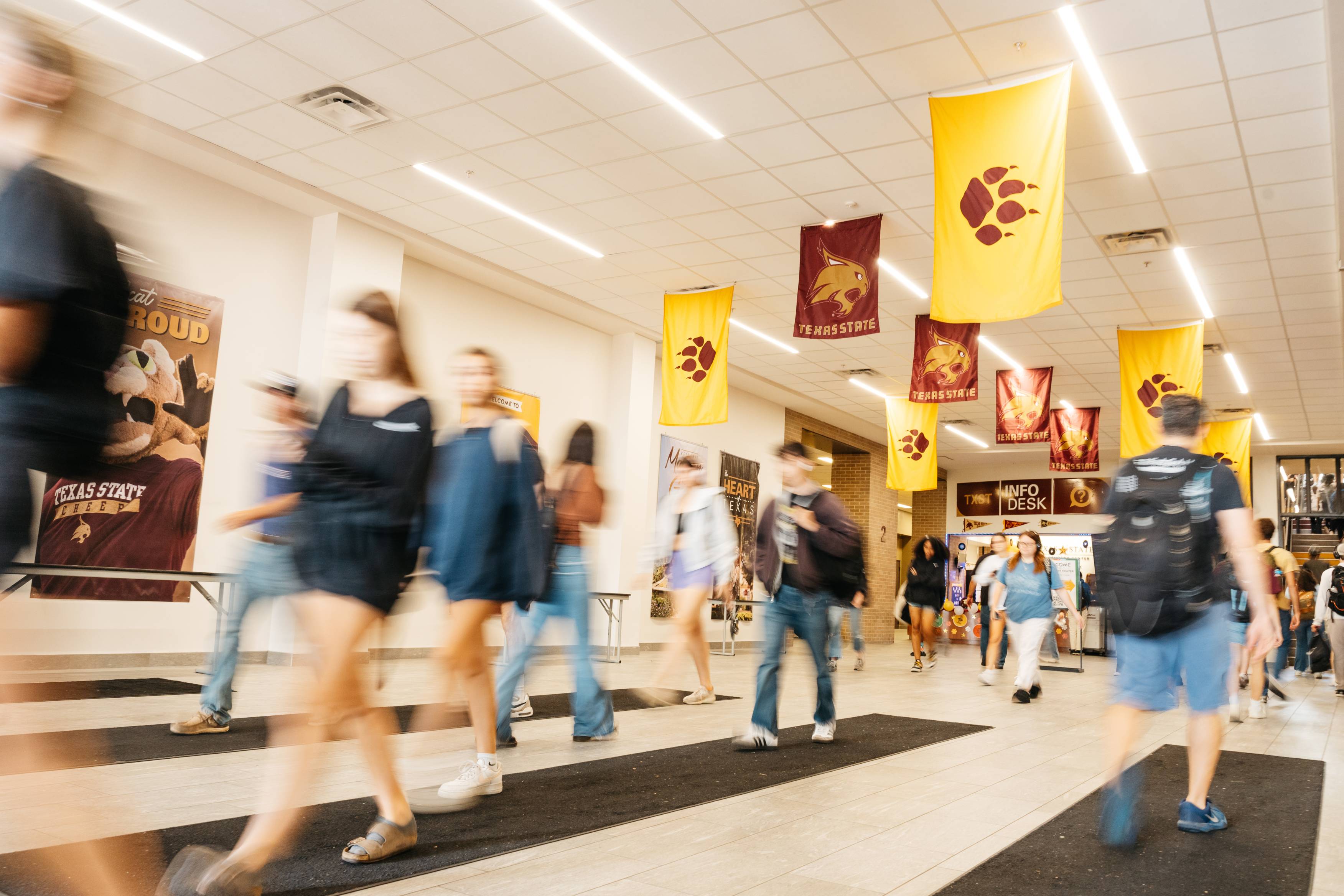 Students quickly traverse a hallway between classes.