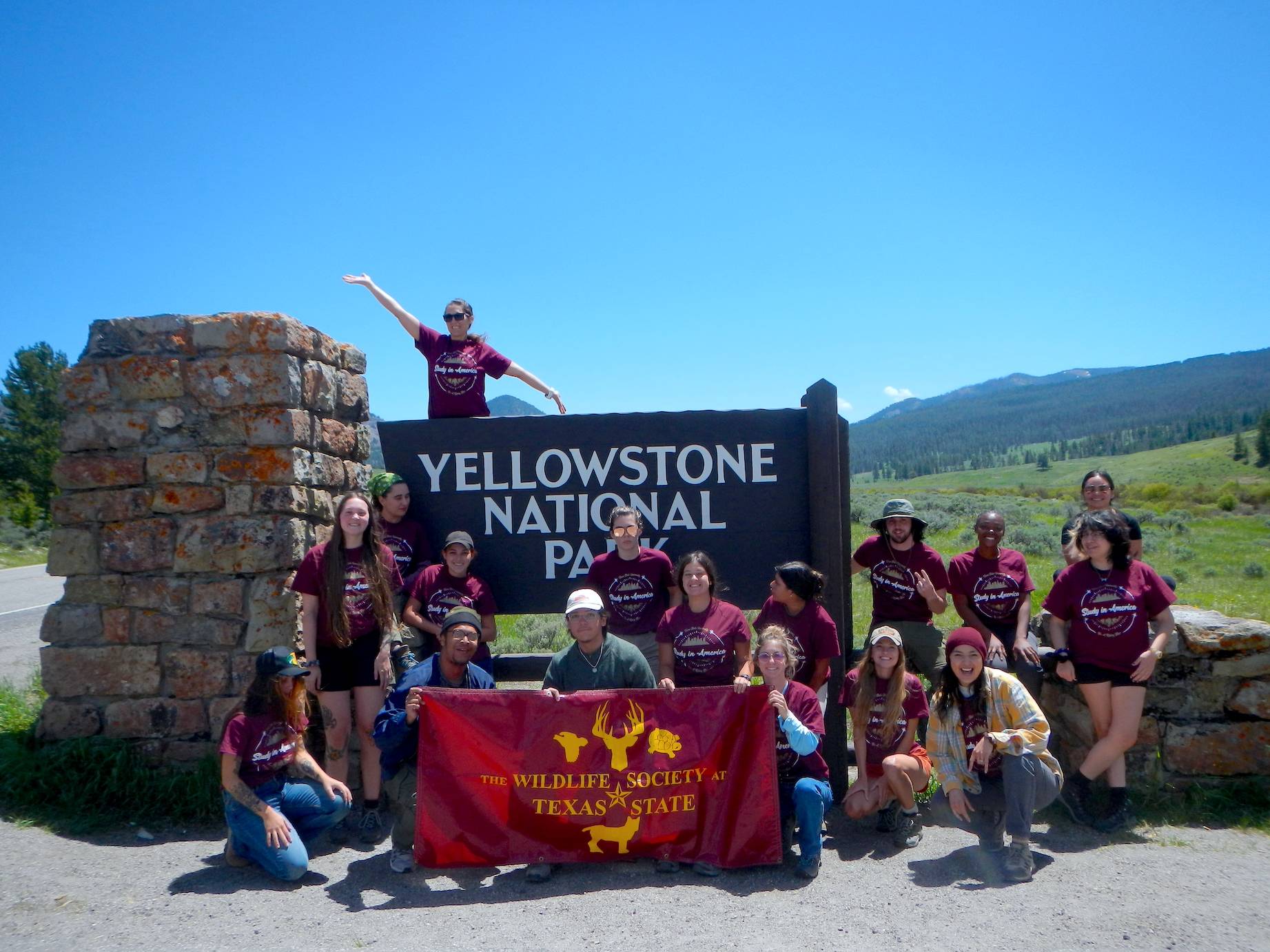 Students posing around a Yosemite National Park Sign