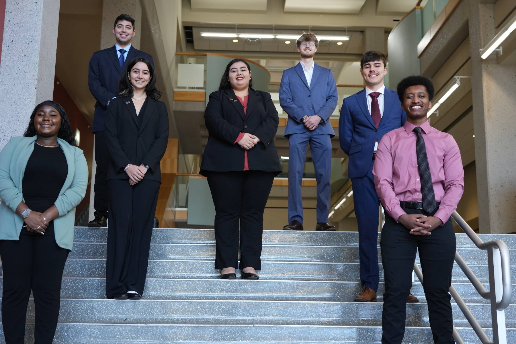Student Business Council members standing on the steps at the front of McCoy Hall