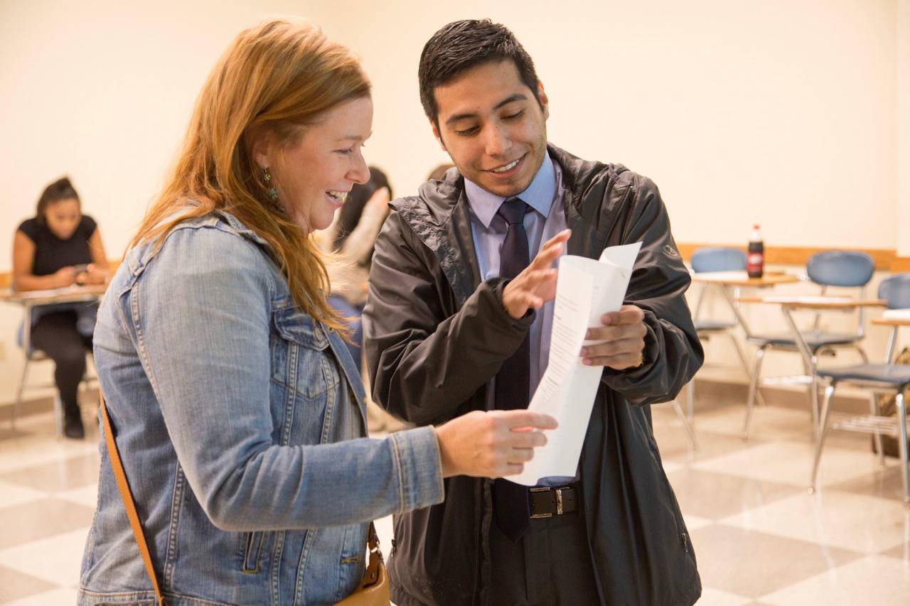 One male and one female looking over a piece of paper