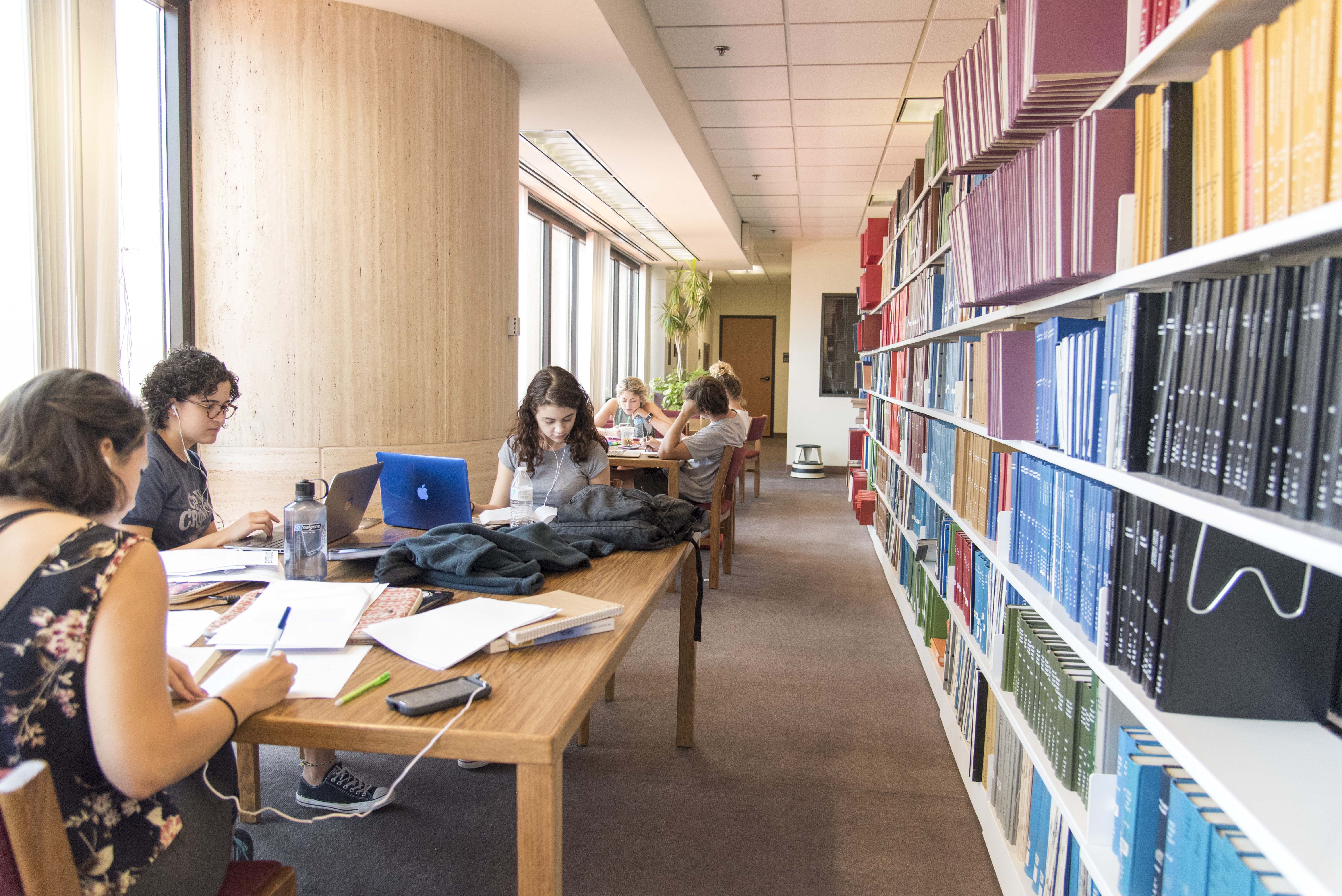 Students sitting at a desk in a library