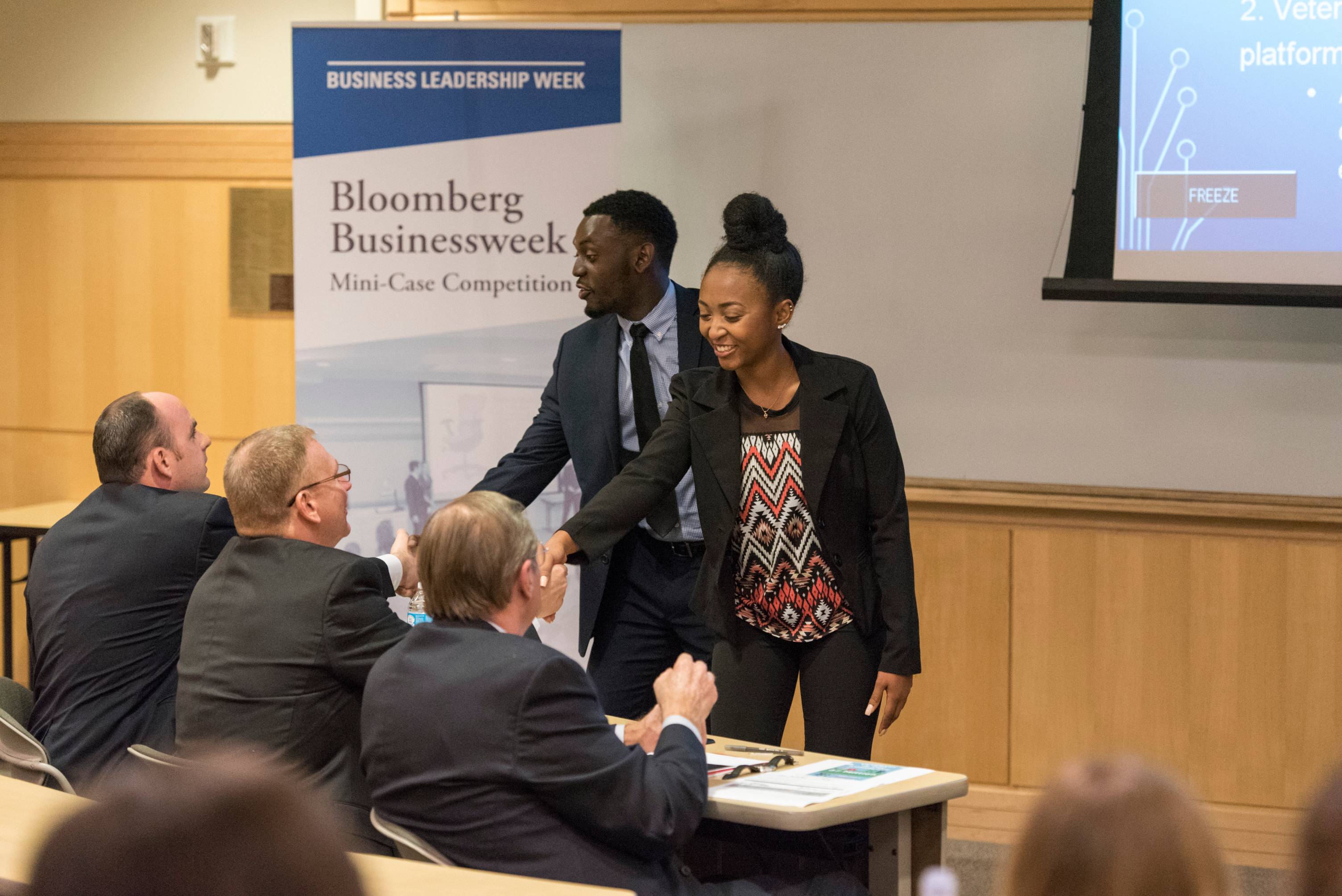 students giving a presentation to executives 