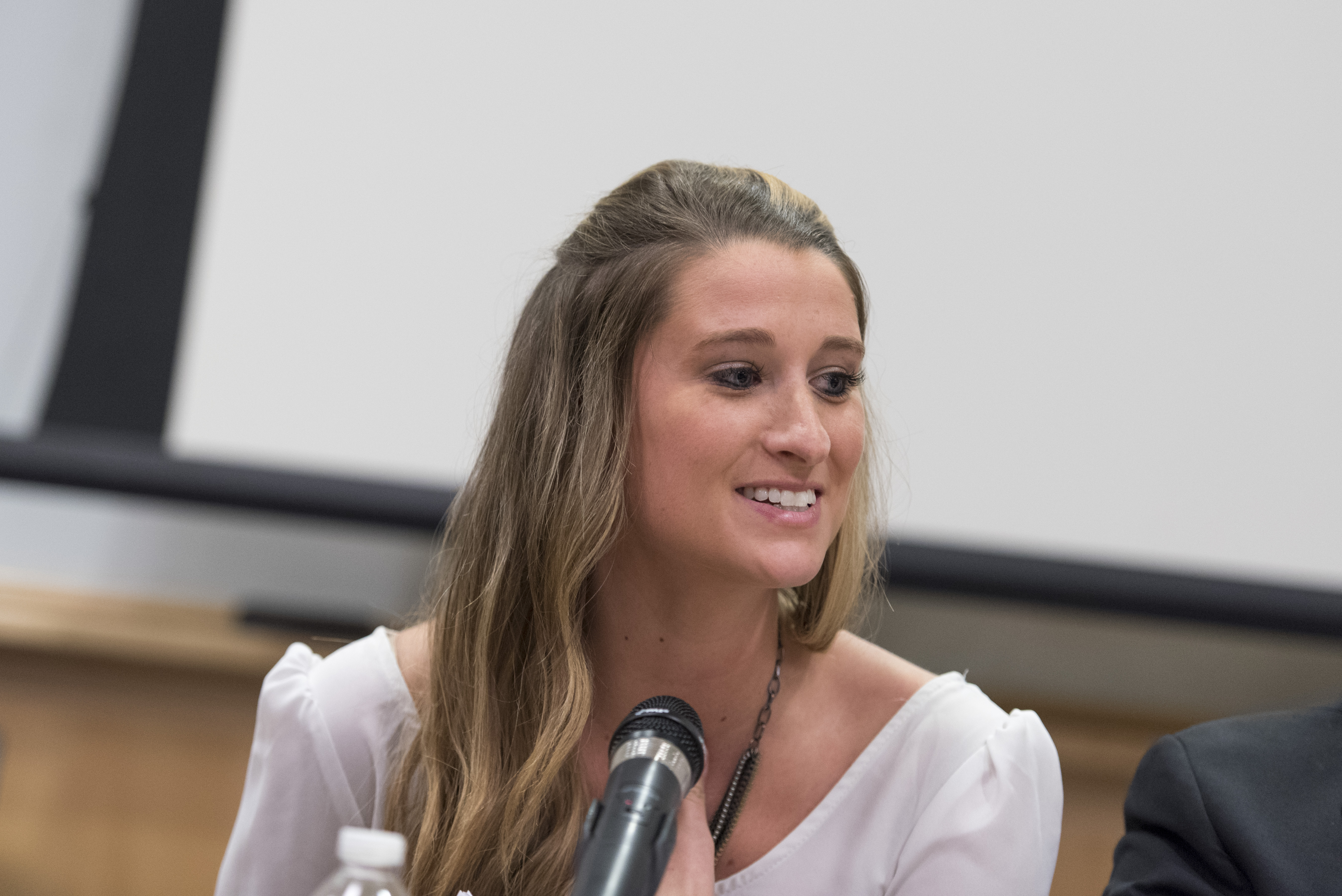 Woman sitting in front of microphone