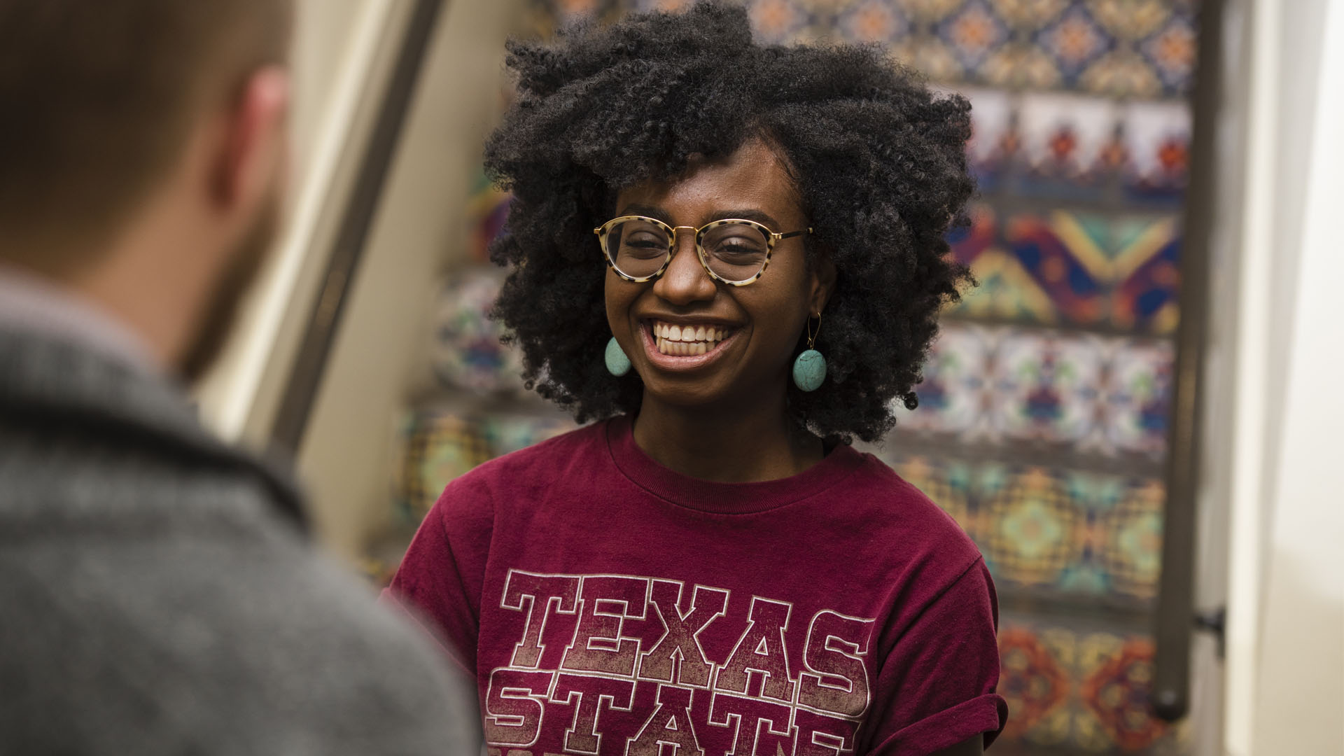 Woman smiling wearing a Texas State shirt.