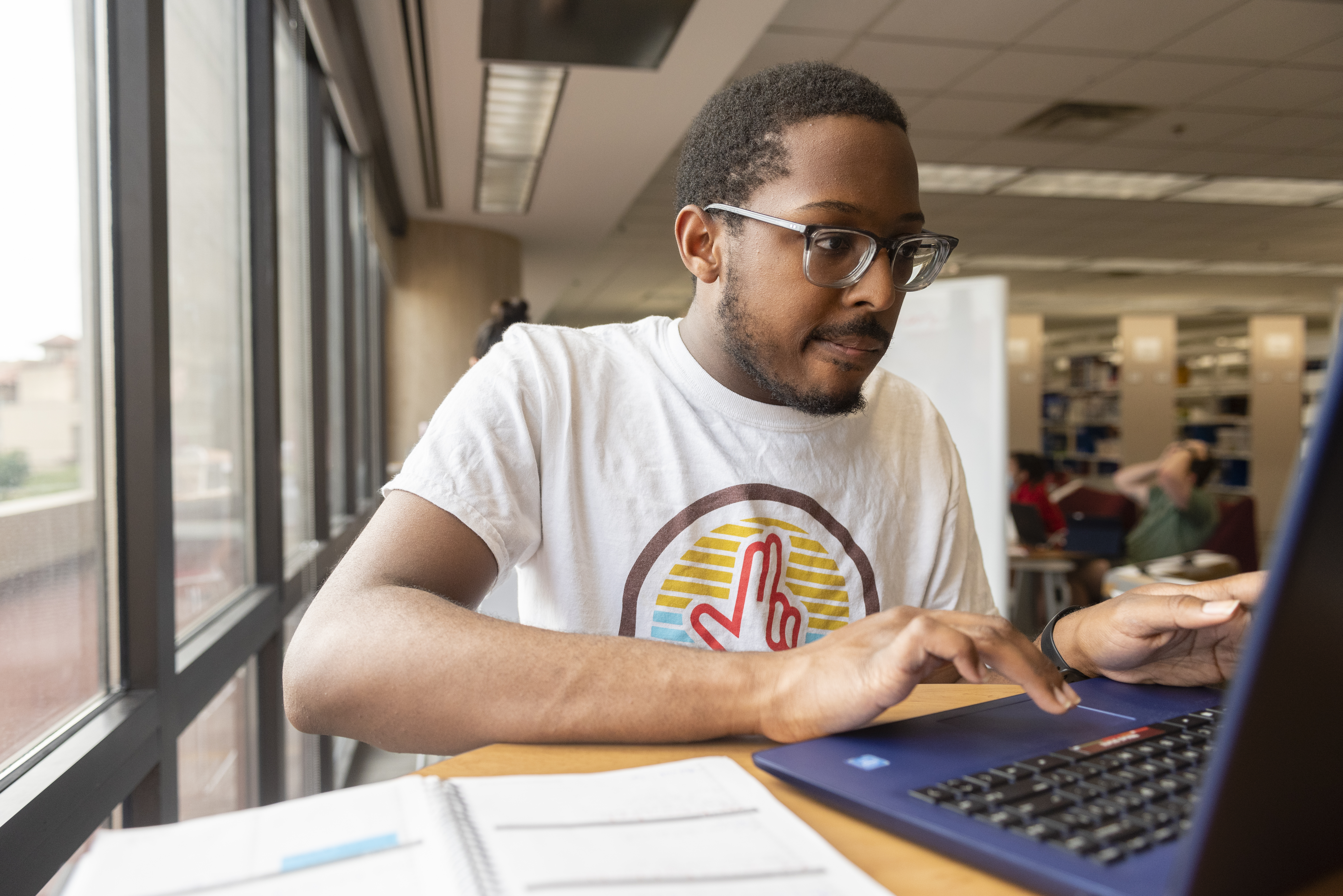 Student working at computer in library