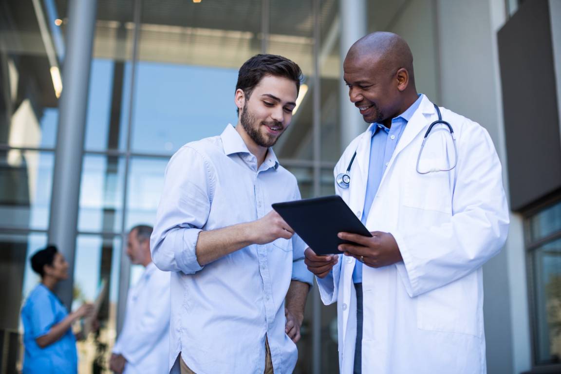 2 medical professionals looking at a tablet