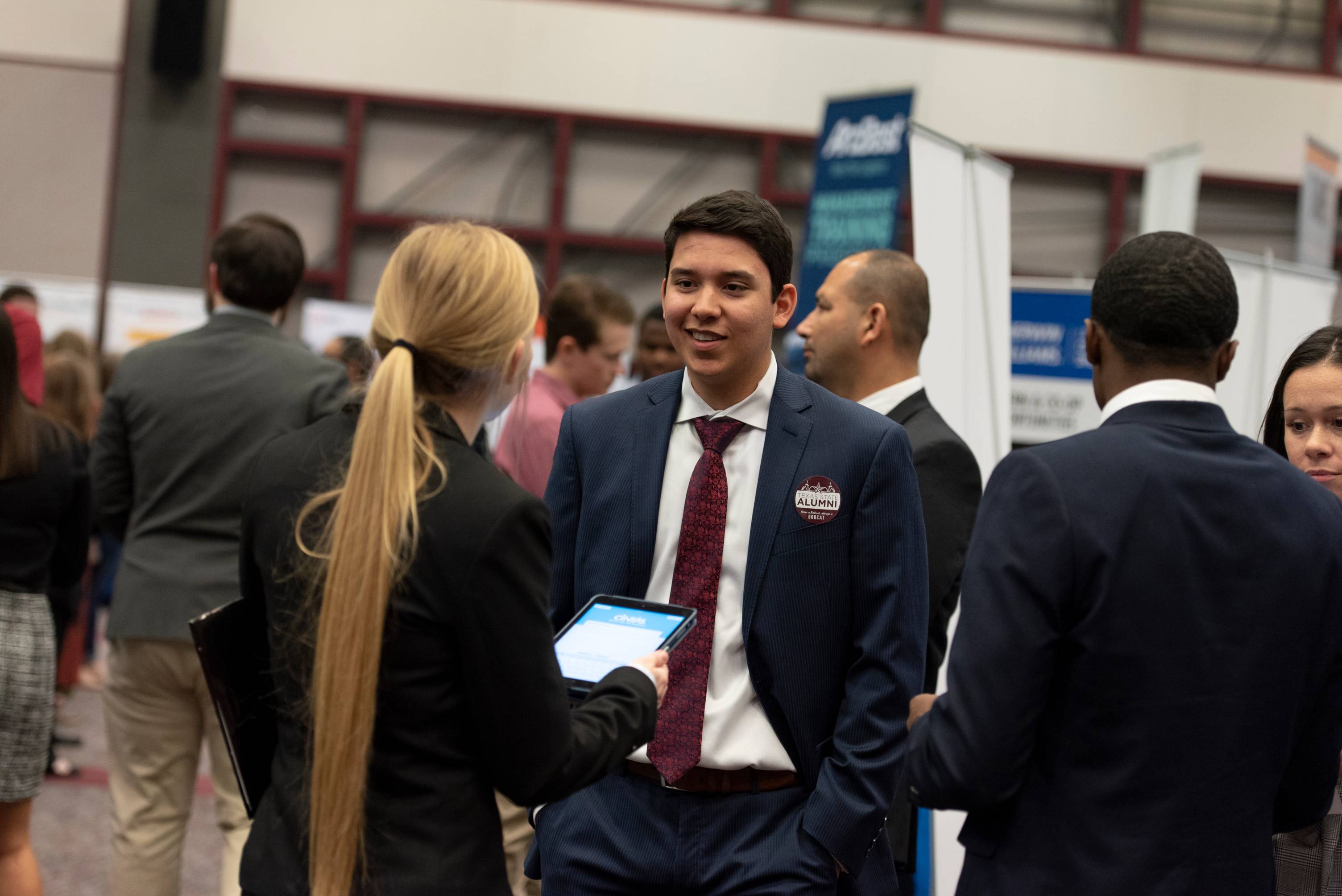 student speaking with an employer at career fair 