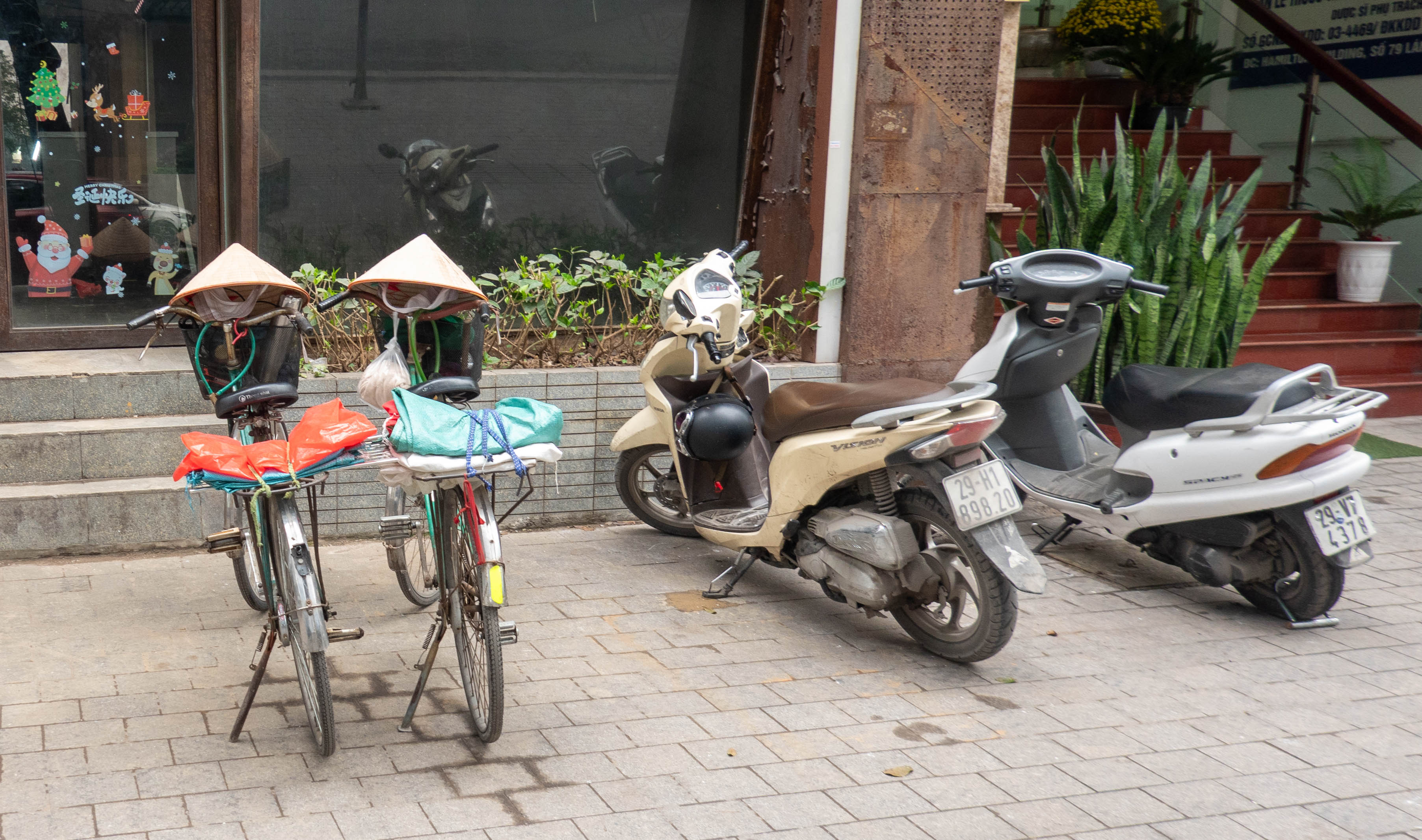 Picture of two bicycles on left and two motorbikes on right