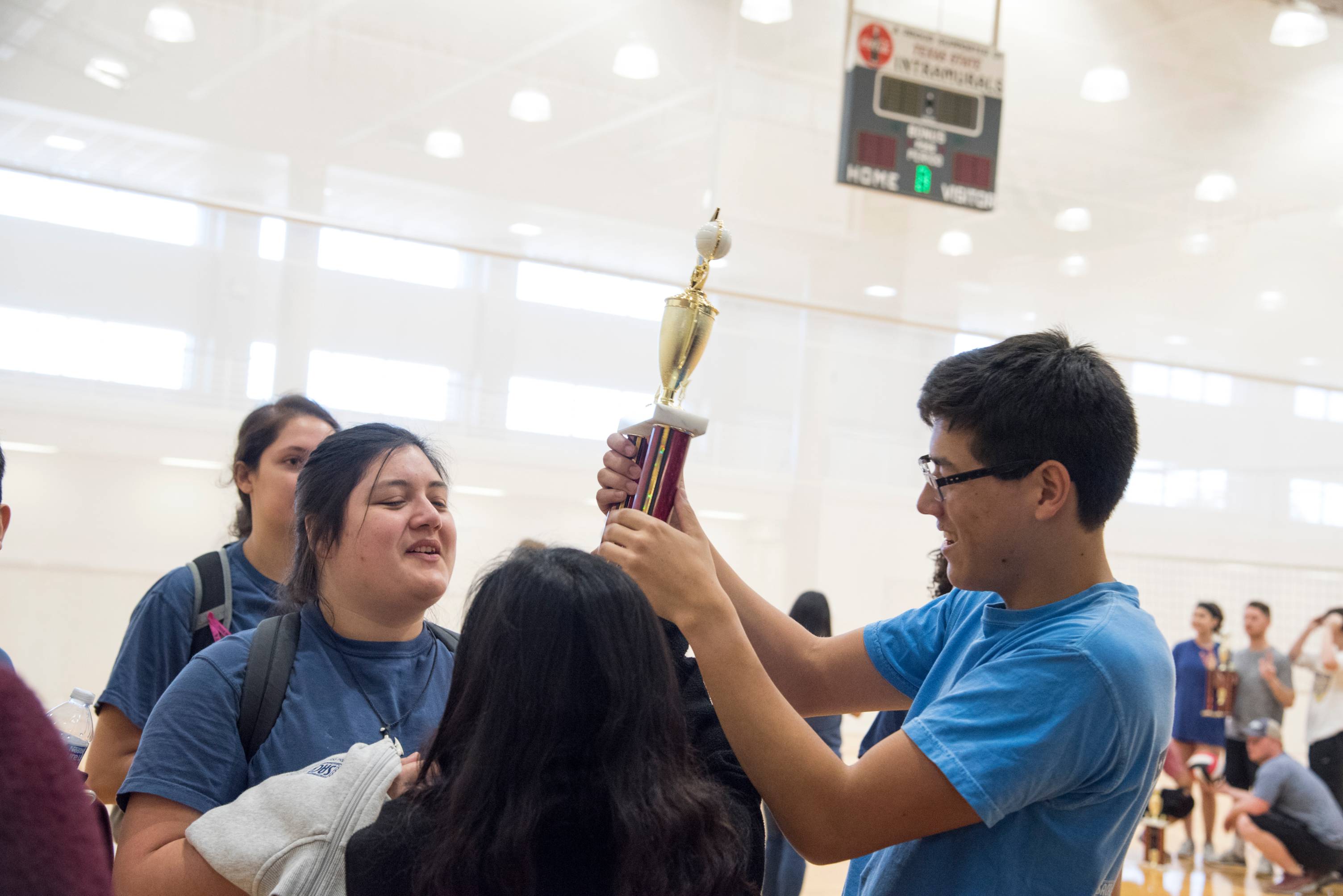 An Image of two students holding a trophy