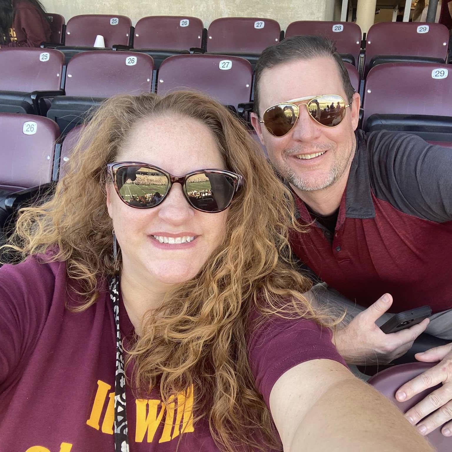 Photo of couple smiling at TXST football game