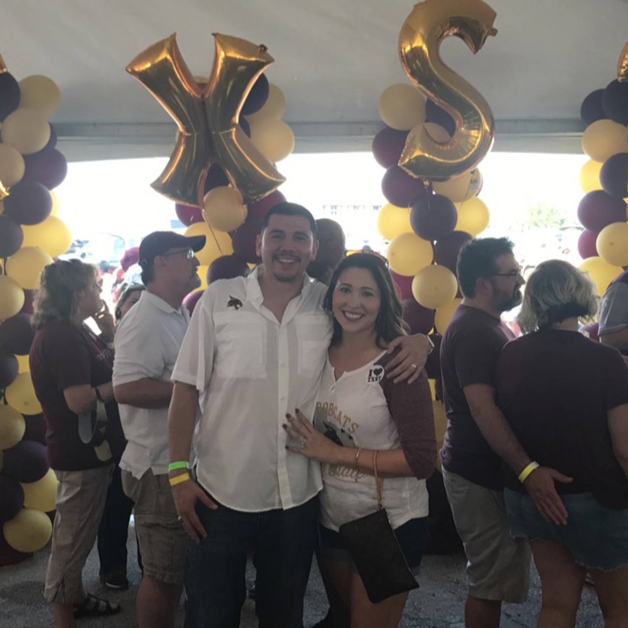 Photo of couple smiling at TXST football game