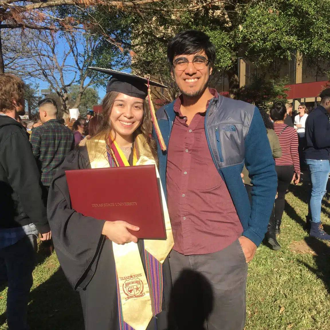 Photo of couple smiling at graduation event