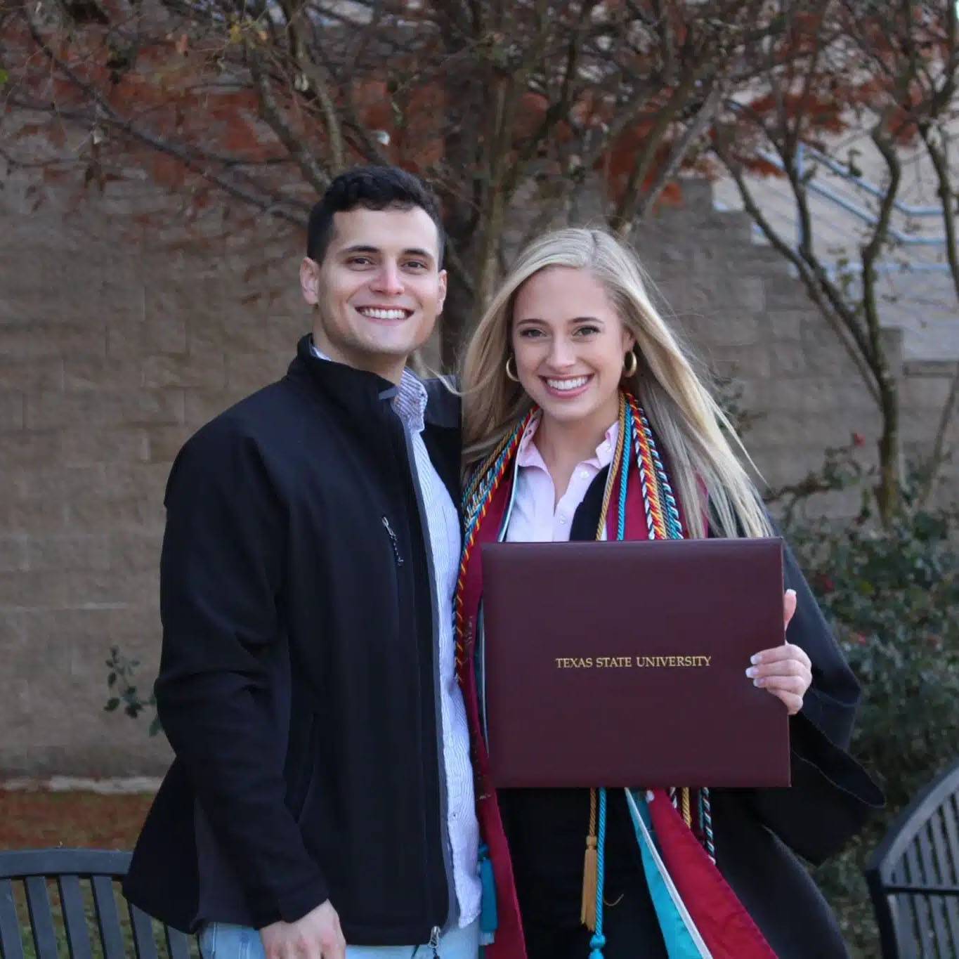 photo of couple smiling at a graduation