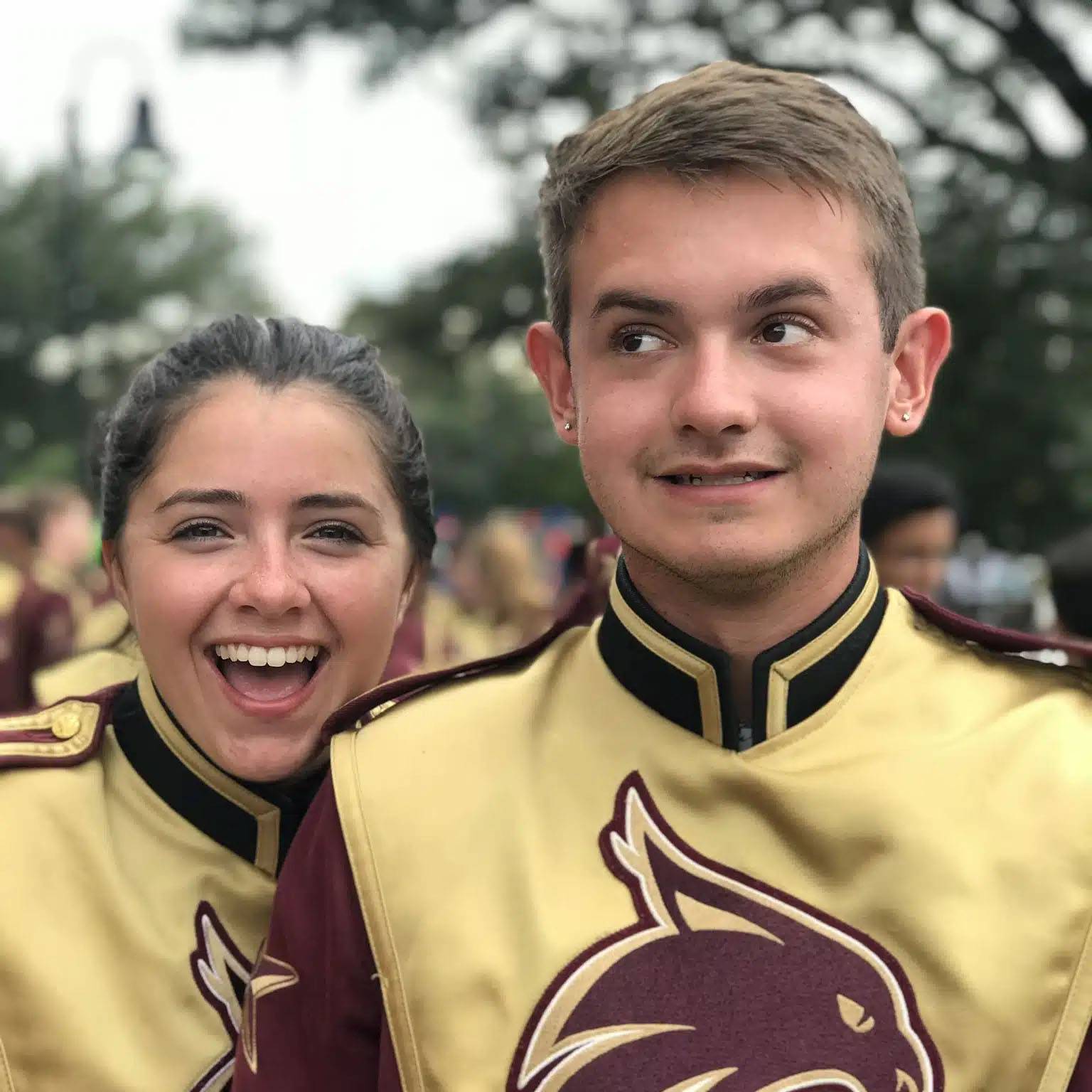 photo of couple smiling in their band uniforms.