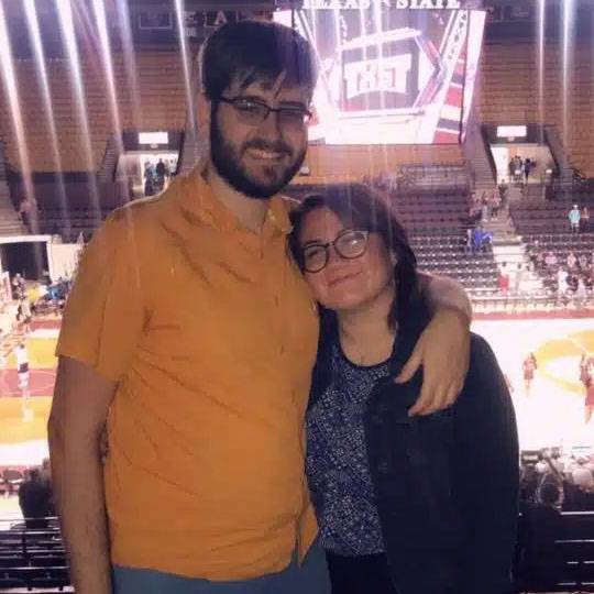 photo of couple standing together at TXST basketball game