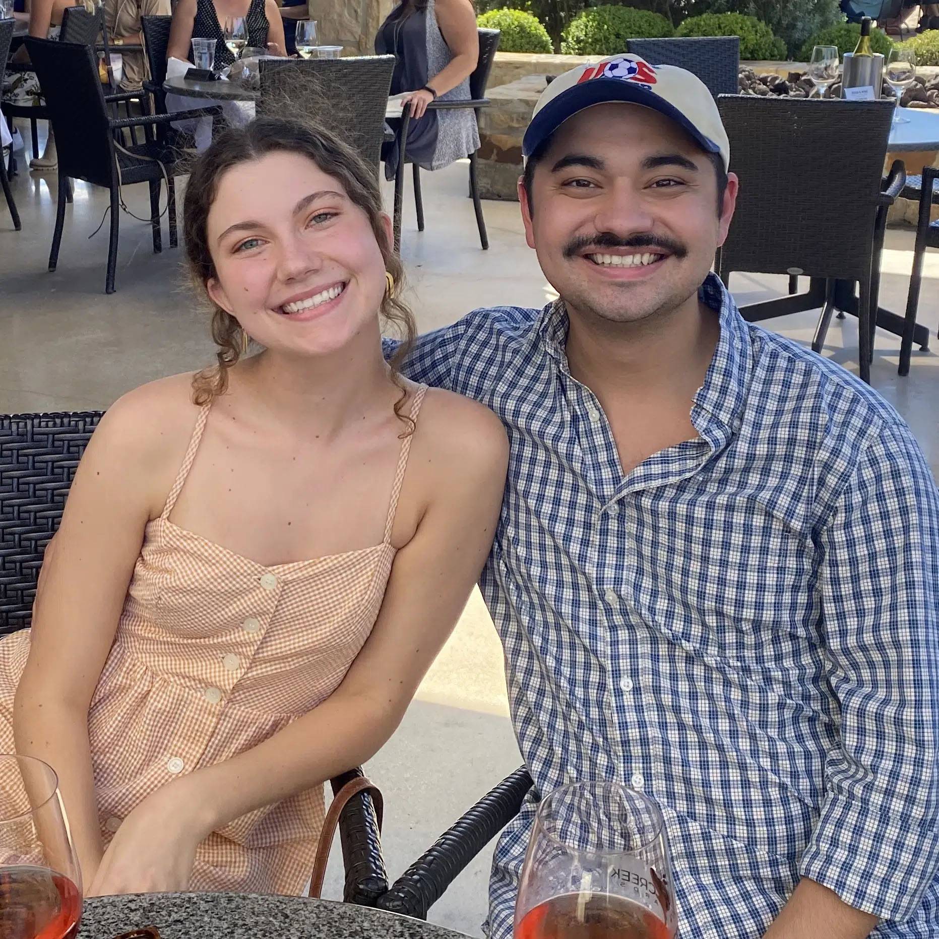 Photo of couple sitting together and smiling in a restaurant