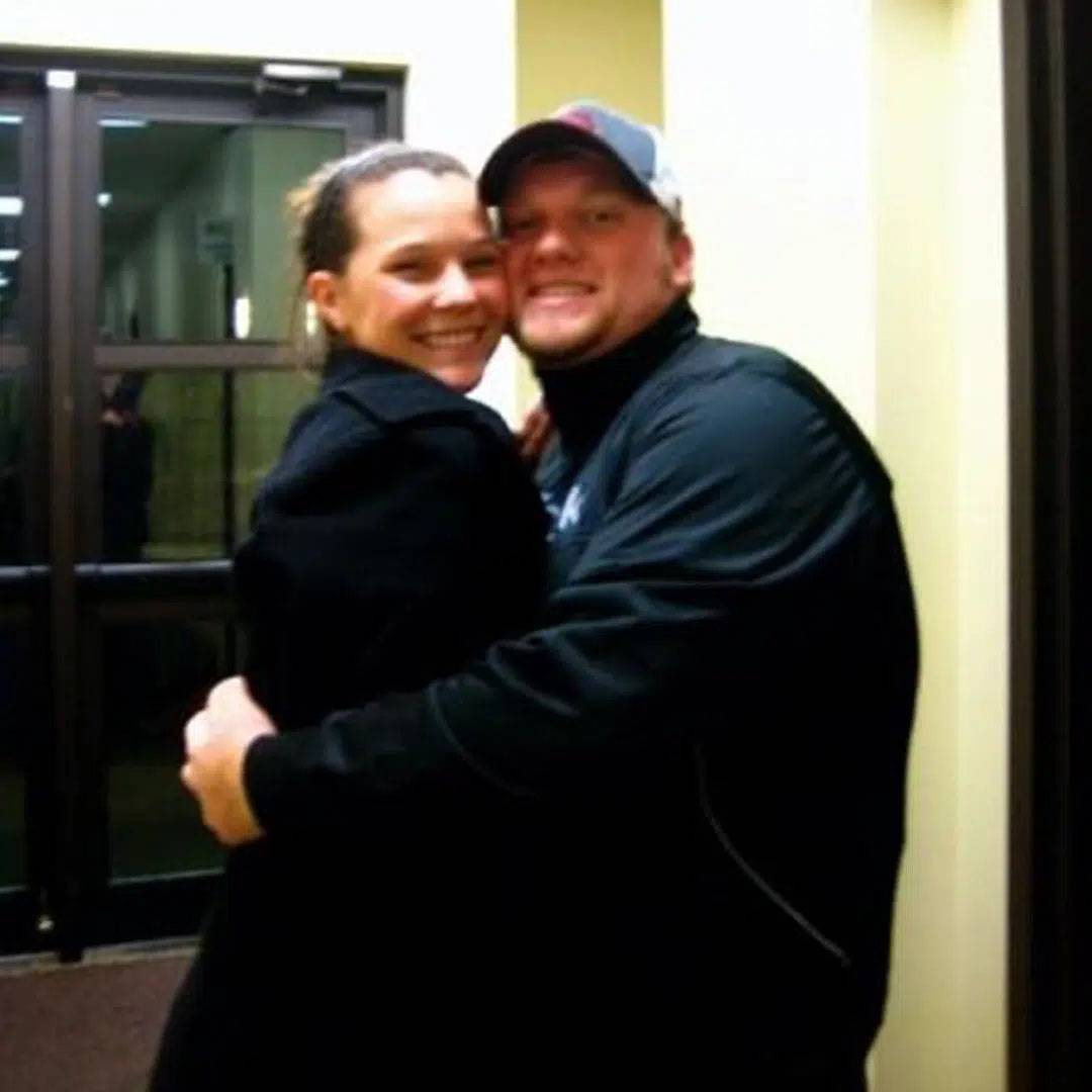 photo of couple wearing all black hugging each other