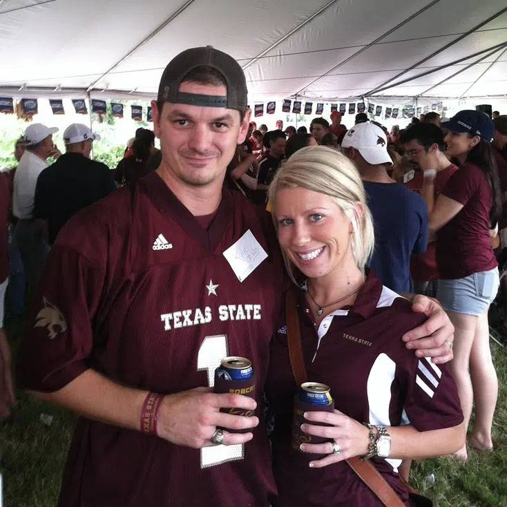 Photo of couple wearing TXST merch at TXST tailgate