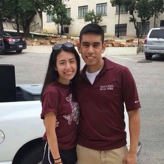 Photo of couple standing together wearing Texas State shirts