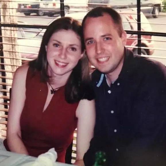 Photo of couple sitting by window sill