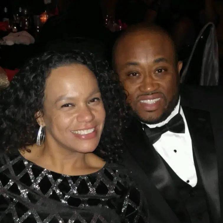 Photo of couple smiling wearing tuxedo and sparkly dress.