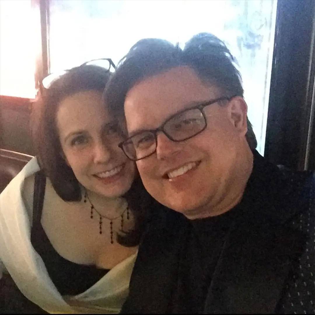 Photo of couple sitting together smiling at a restaurant.