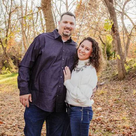 photo of couple smiling in the woods